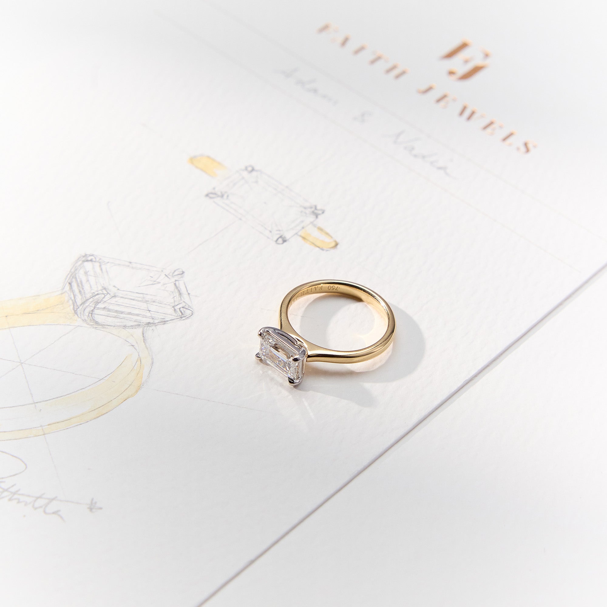 Emerald-cut East-West Engagement Diamond Ring in yellow gold with white gold claws, a modern yet timeless elegant design.