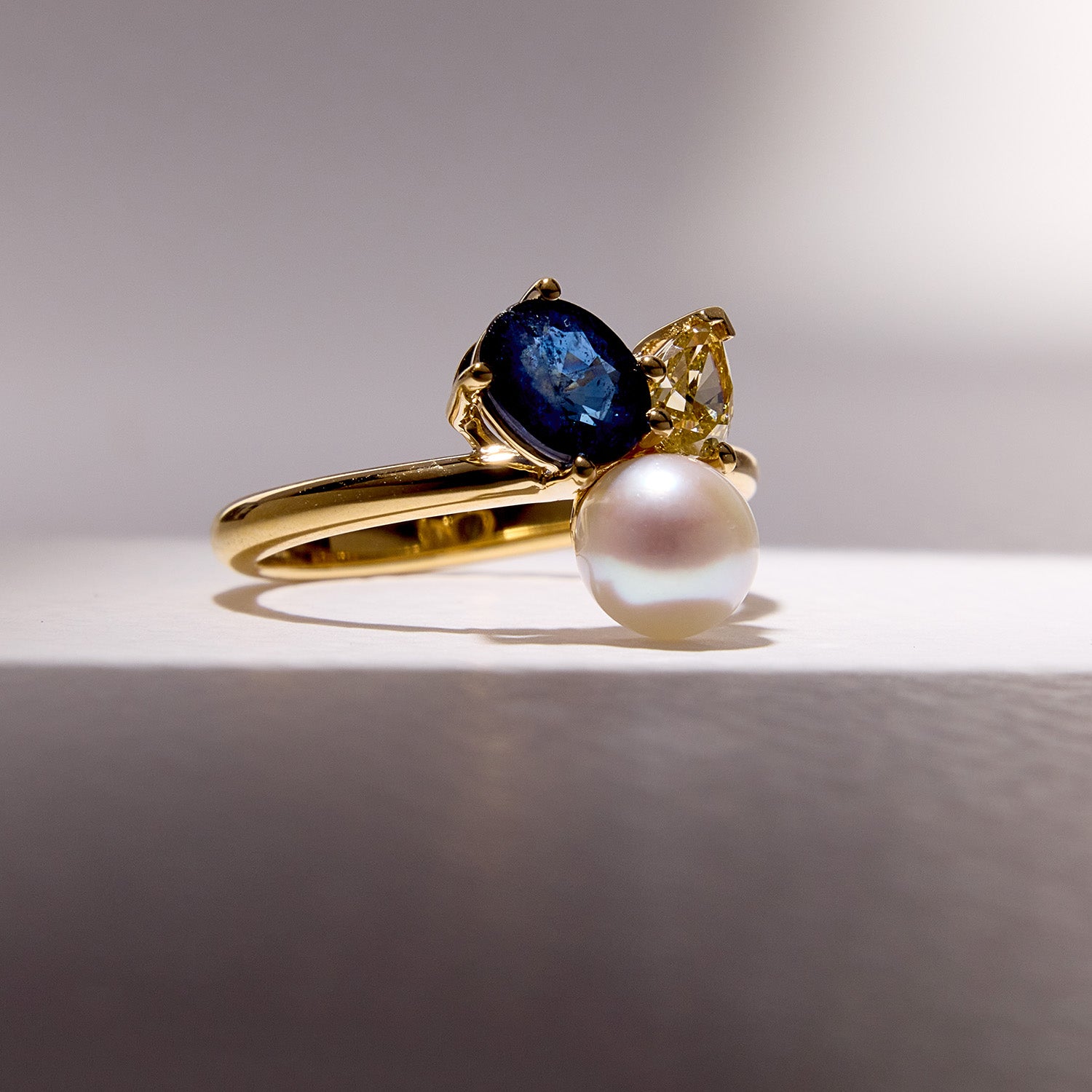 Bespoke Sapphire Pearl Bouquet Ring crafted in 18k yellow gold, featuring blue sapphire, yellow diamond and a luminous pearl.