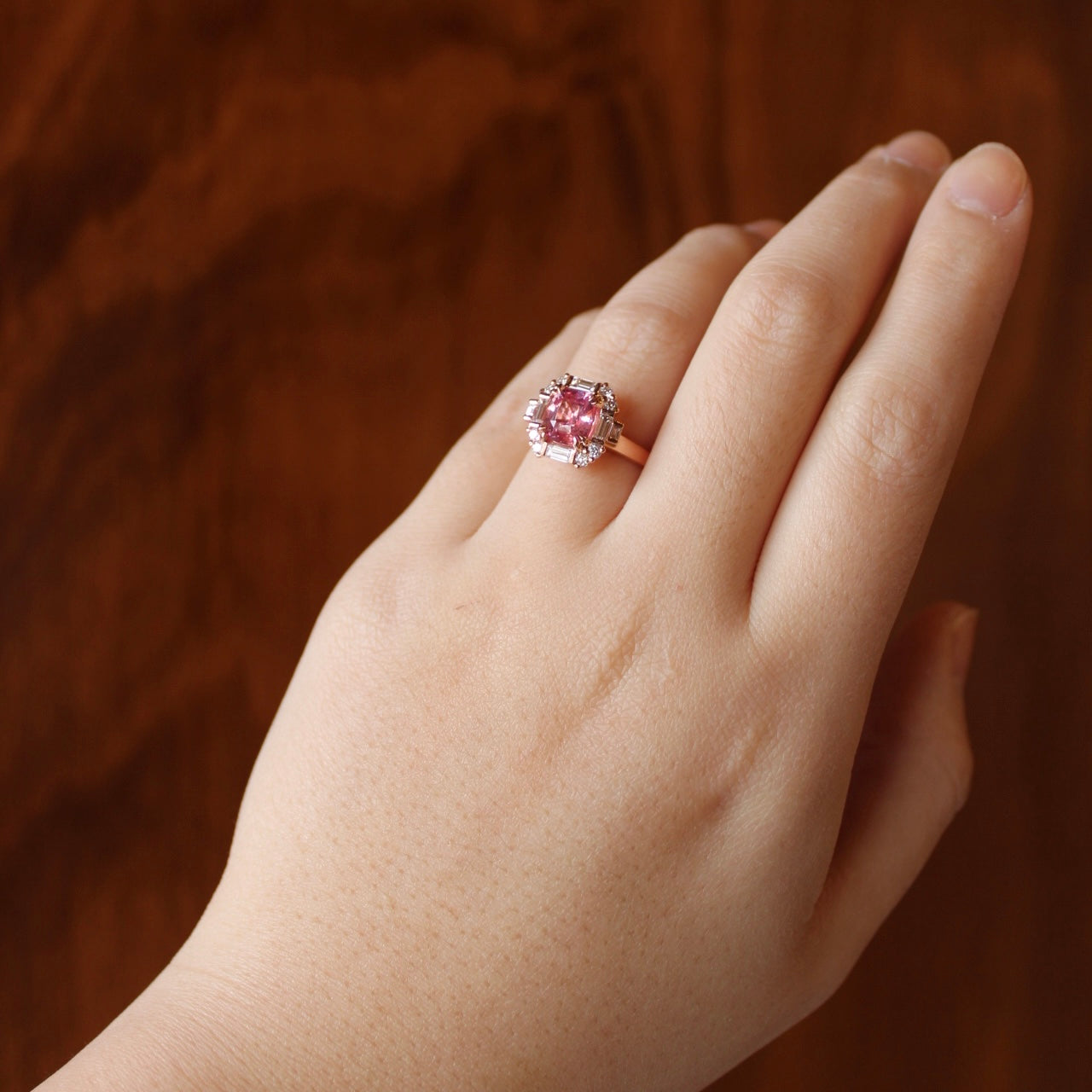 Art Deco inspired Padparadscha sapphire ring with diamonds in 18k rose gold