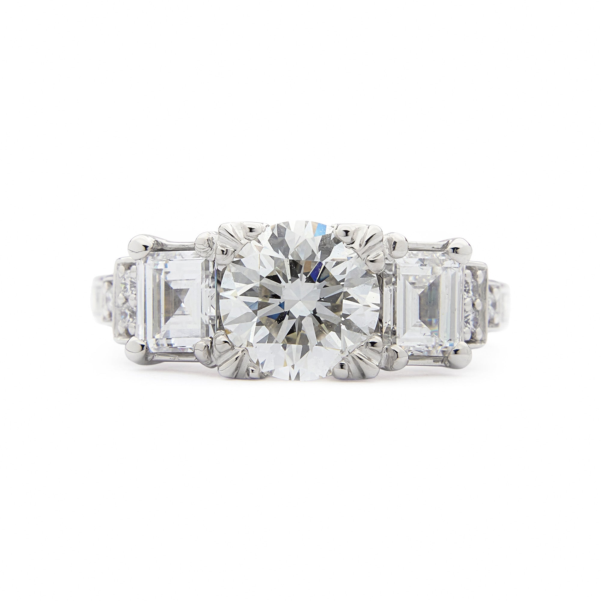 Heirloom Empire Ring with central family diamond, Art Deco trilogy design, and side diamonds in elegant setting.