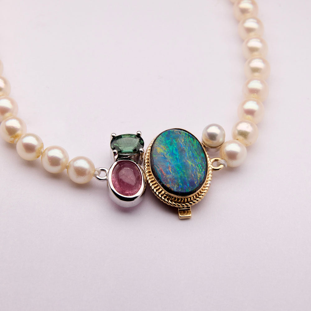 Faith Jewels Heirloom pearl necklace with a unique clasp made from opal, tourmaline, and mixed metals, blending family gemstones into a modern statement piece.
