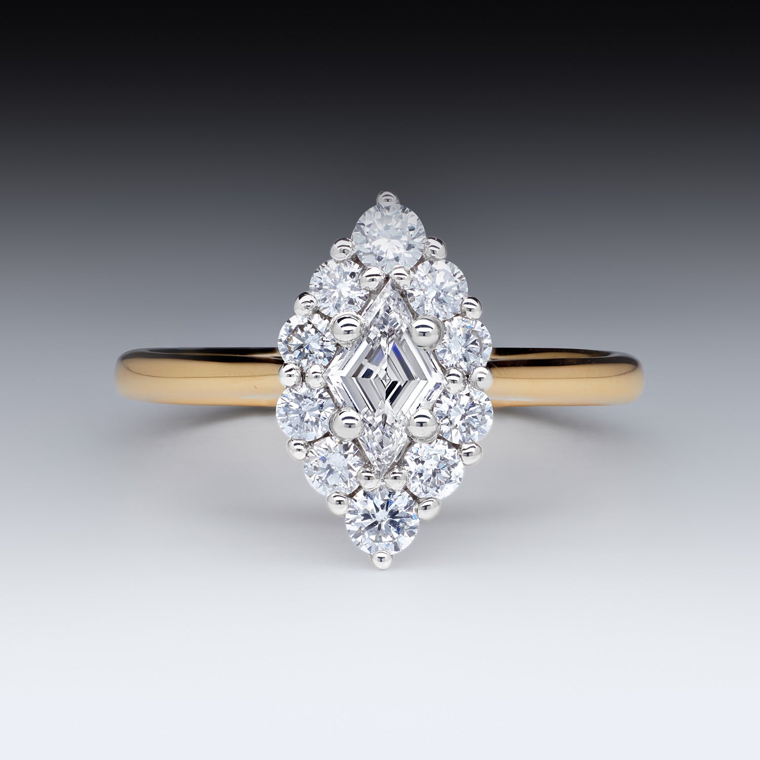 Faith Jewels Adeline Diamond Ring featuring a 0.29ct lozenge step-cut D colour diamond with a halo of round white diamonds, set in 18k white and yellow gold