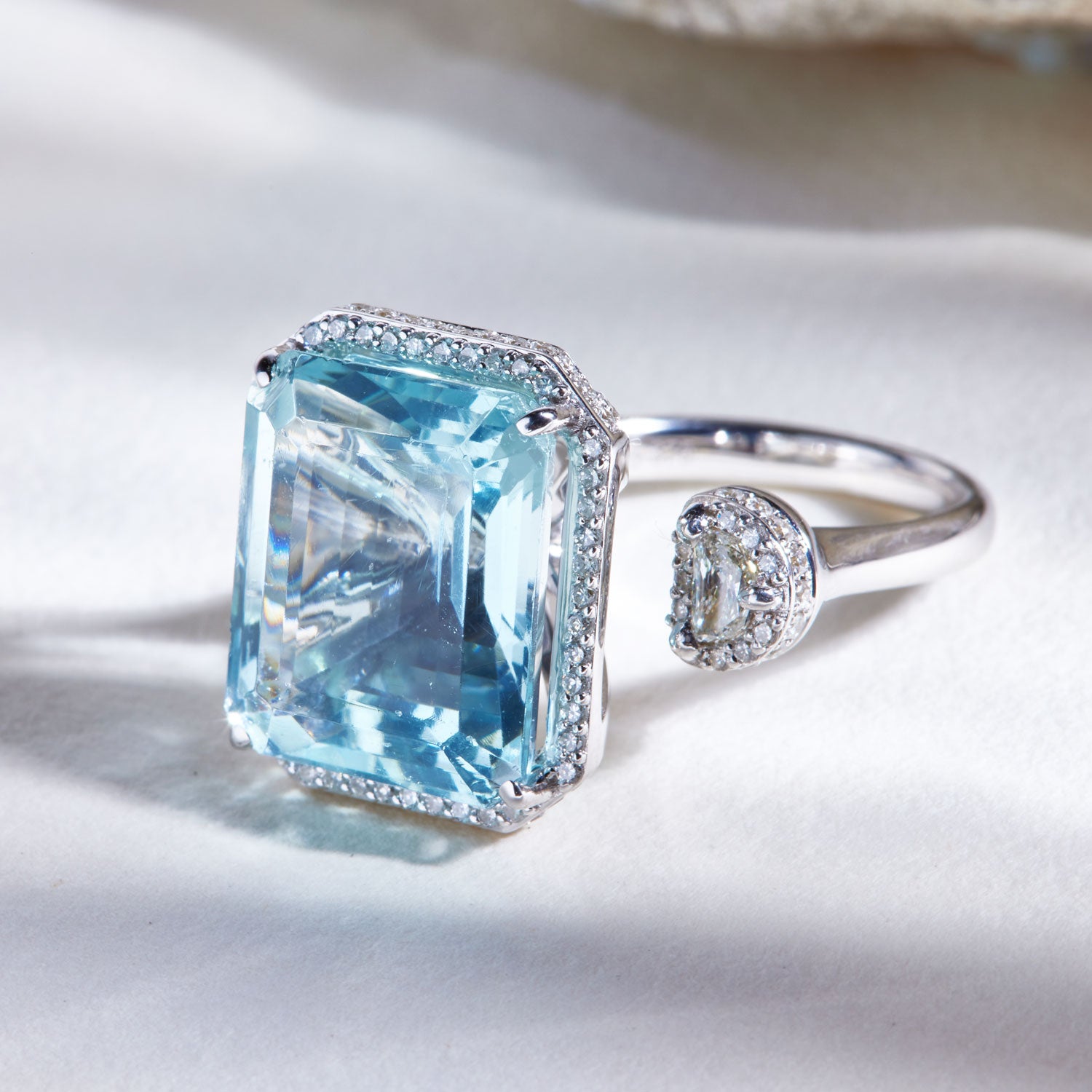 Faith Jewels Toi et Moi ring featuring a 15ct emerald-cut aquamarine and a half-moon white diamond, accented with pavé diamonds