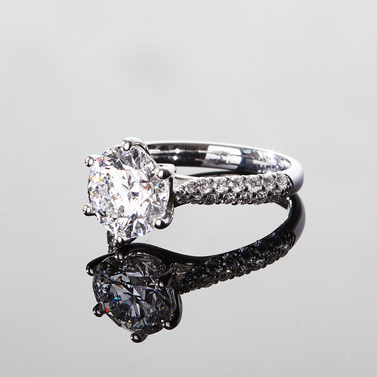 Faith Jewels Arlene diamond engagement ring featuring a 3ct round brilliant-cut solitaire diamond in a twist-setting with an asymmetrical pavé diamond band