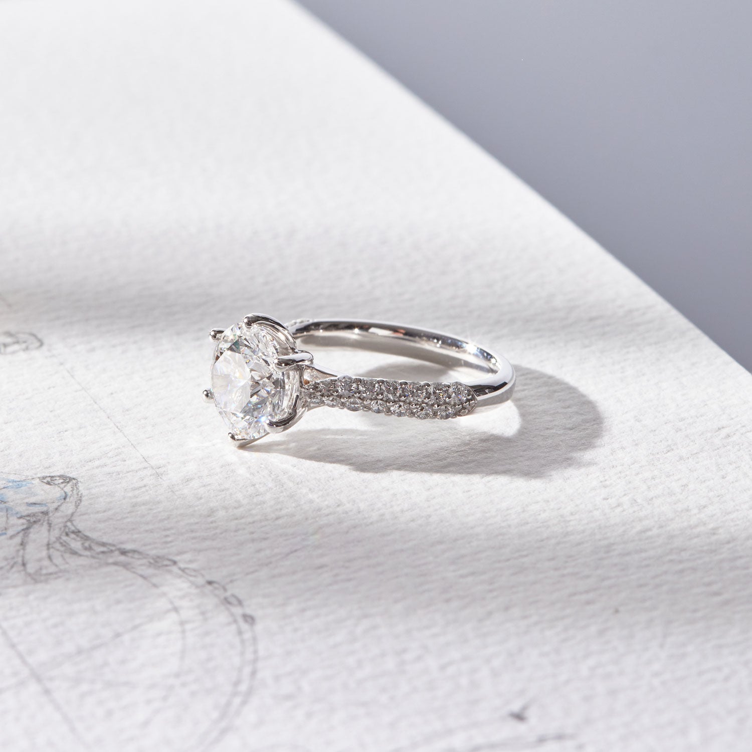 Faith Jewels Arlene diamond engagement ring featuring a 3ct round brilliant-cut solitaire diamond in a twist-setting with an asymmetrical pavé diamond band