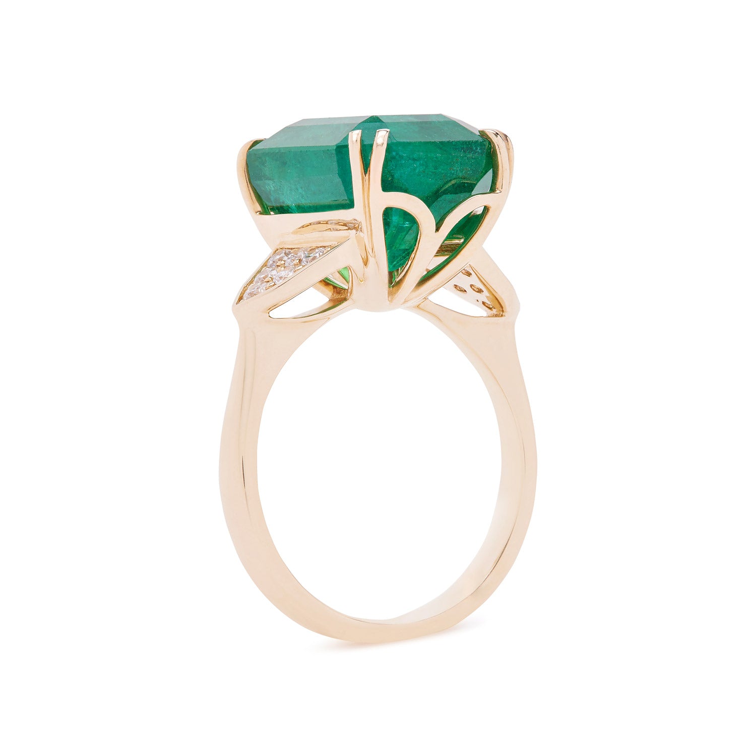 Emerald-cut emerald ring with grain-set diamond accents, set in a yellow gold band.