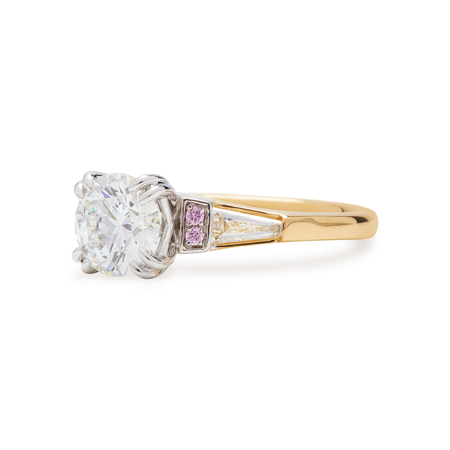 Faith Jewels Faith engagement ring featuring a round brilliant-cut diamond center, flanked by tapered baguette diamonds and accented with Australian Argyle Pink Diamonds