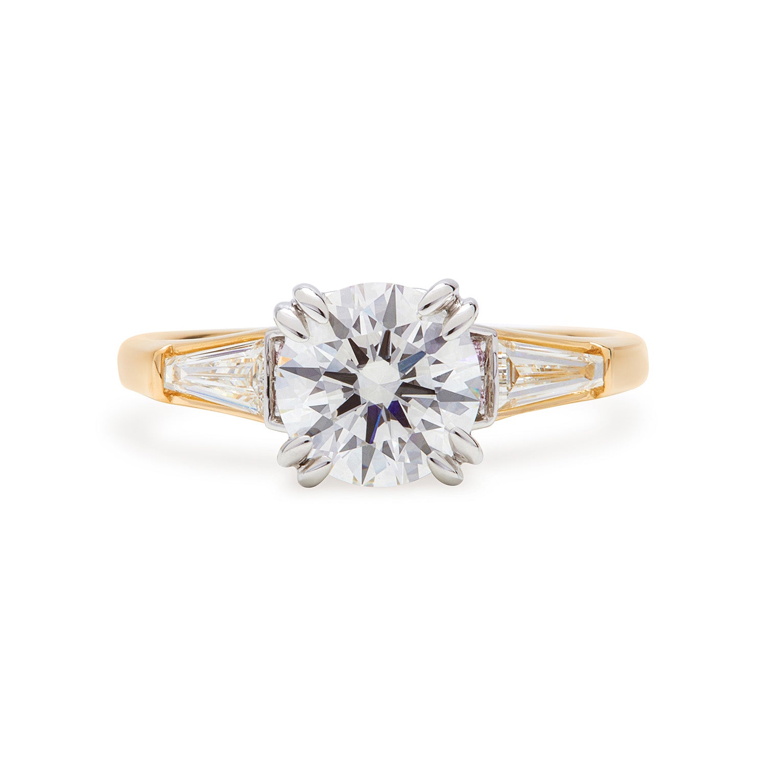 Faith Jewels Faith engagement ring featuring a round brilliant-cut diamond center, flanked by tapered baguette diamonds and accented with Australian Argyle Pink Diamonds