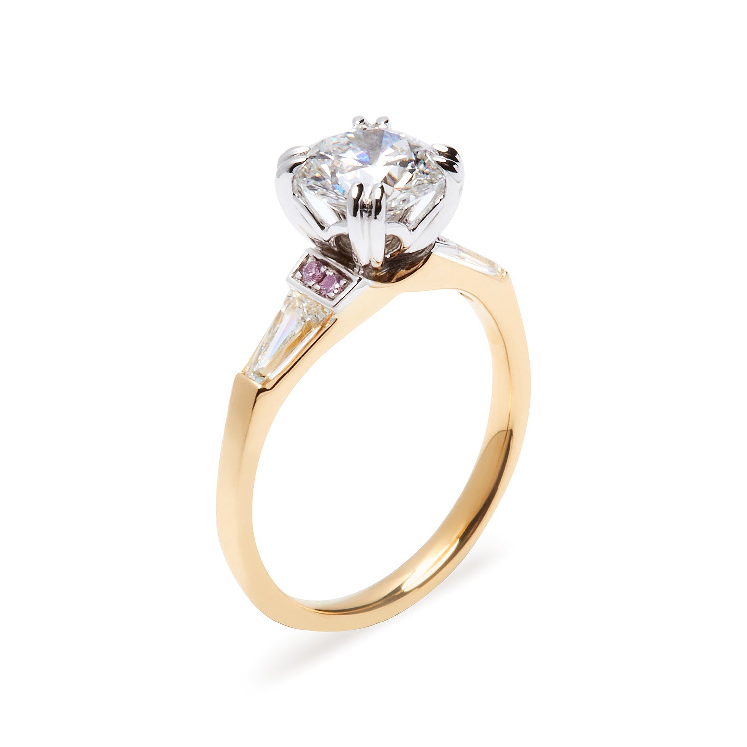 Faith Jewels Faith engagement ring featuring a round brilliant-cut diamond center, flanked by tapered baguette diamonds and accented with Australian Argyle Pink Diamonds