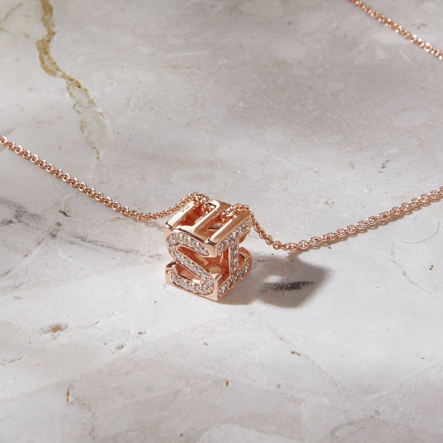 Bespoke Initial Cube Pendant Necklace featuring a customizable 3D cube design with initial S and I, suspended from a fine rose gold trace chain