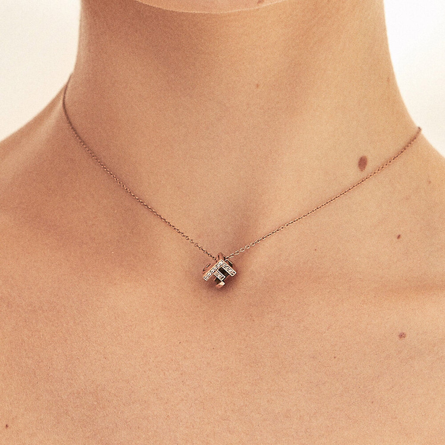Bespoke Initial Cube Pendant Necklace featuring a love 3D cube design with diamonds initial F, suspended from a fine rose gold trace chain