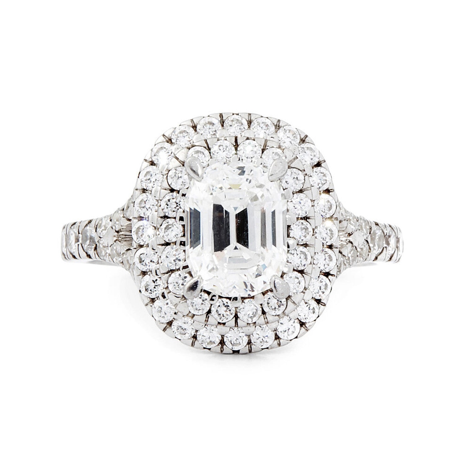 Faith Jewels Sara diamond engagement ring with a raised emerald-cut diamond surrounded by a double halo of brilliant diamonds and a pavé-set split band