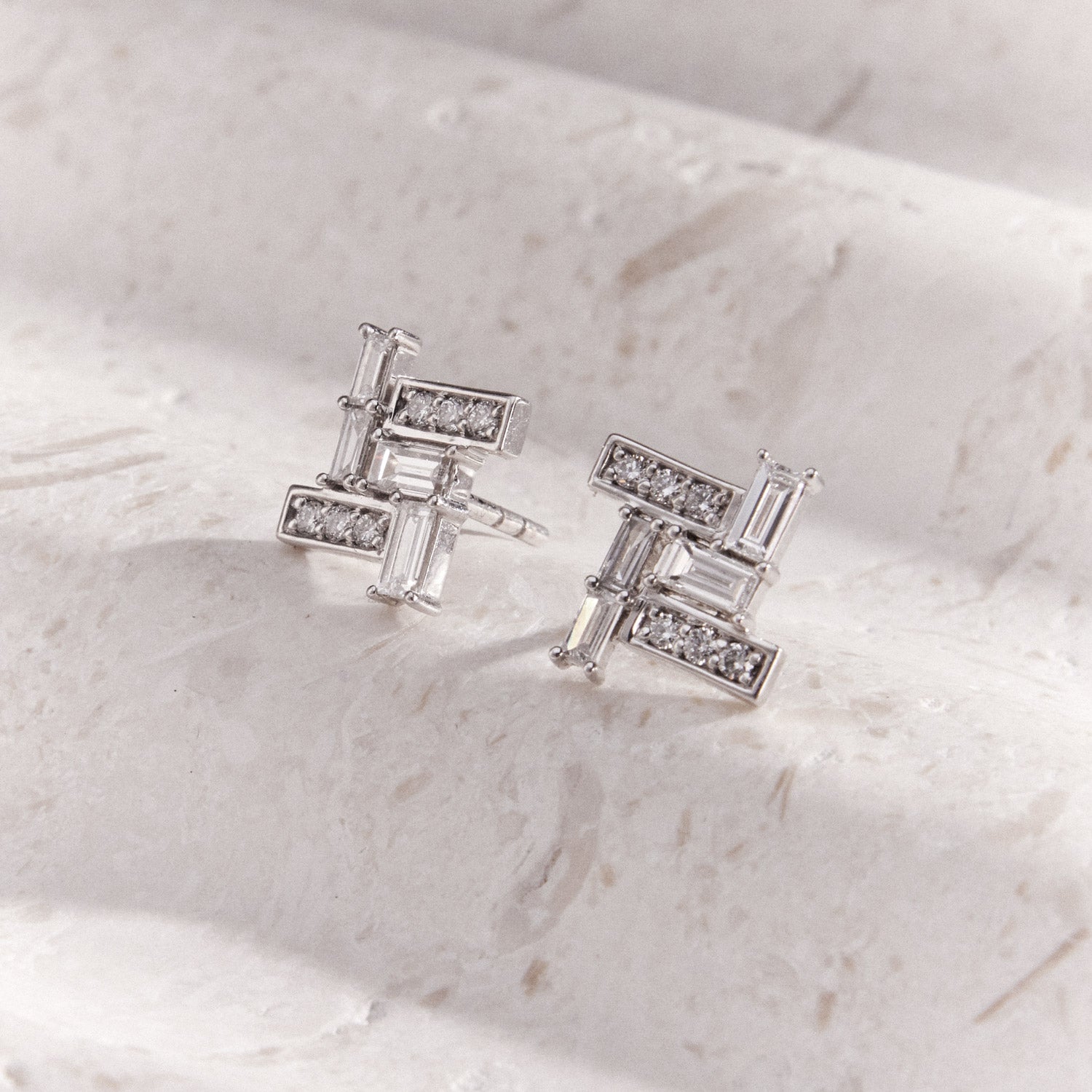 Faith Jewels Skyline Diamond Earrings featuring a geometric design with baguette and round-cut diamonds set in white gold