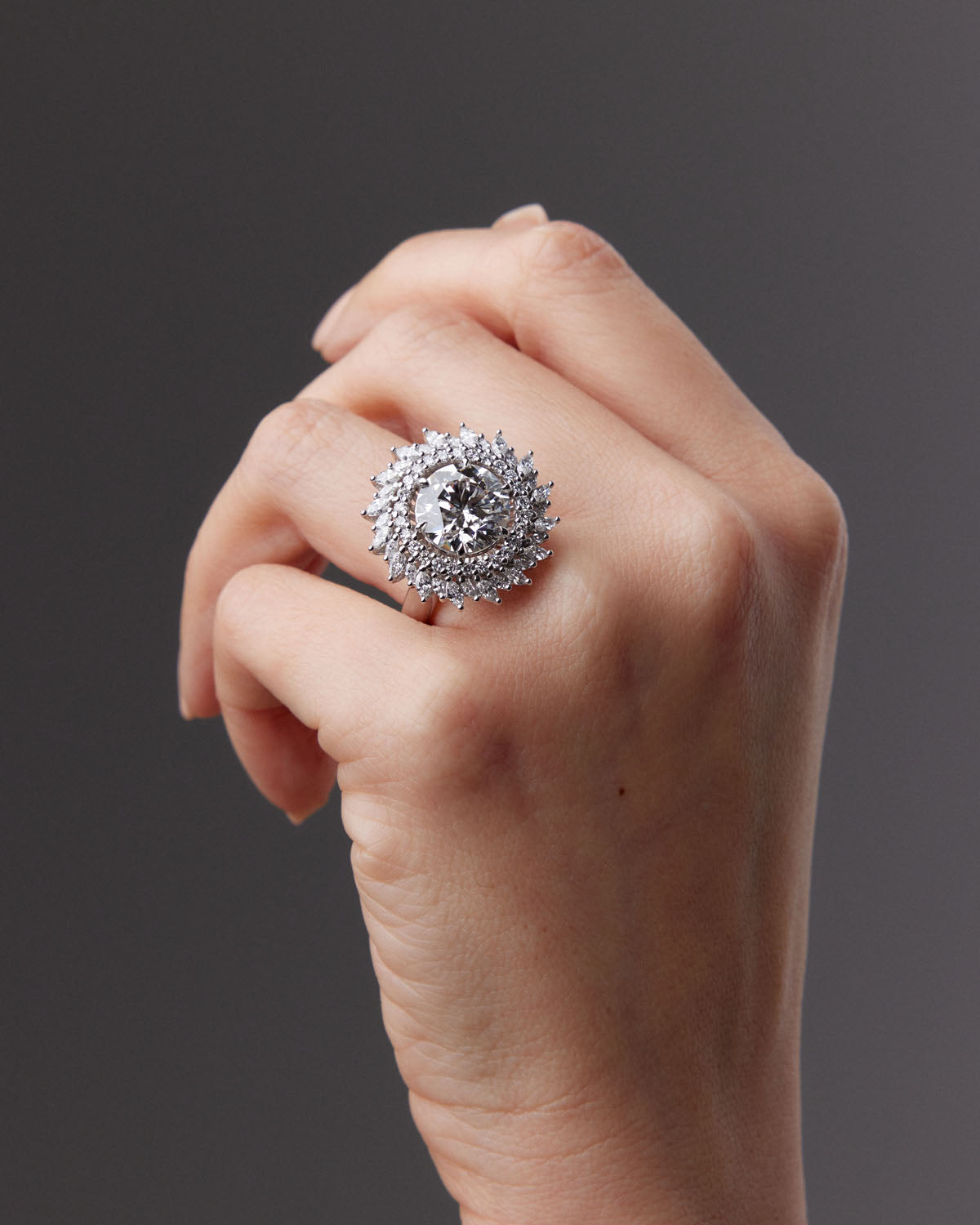 Sunburst Diamond Engagement Ring with a round-cut center diamond, surrounded by a pinwheel halo of round and marquise diamonds in 18k white gold