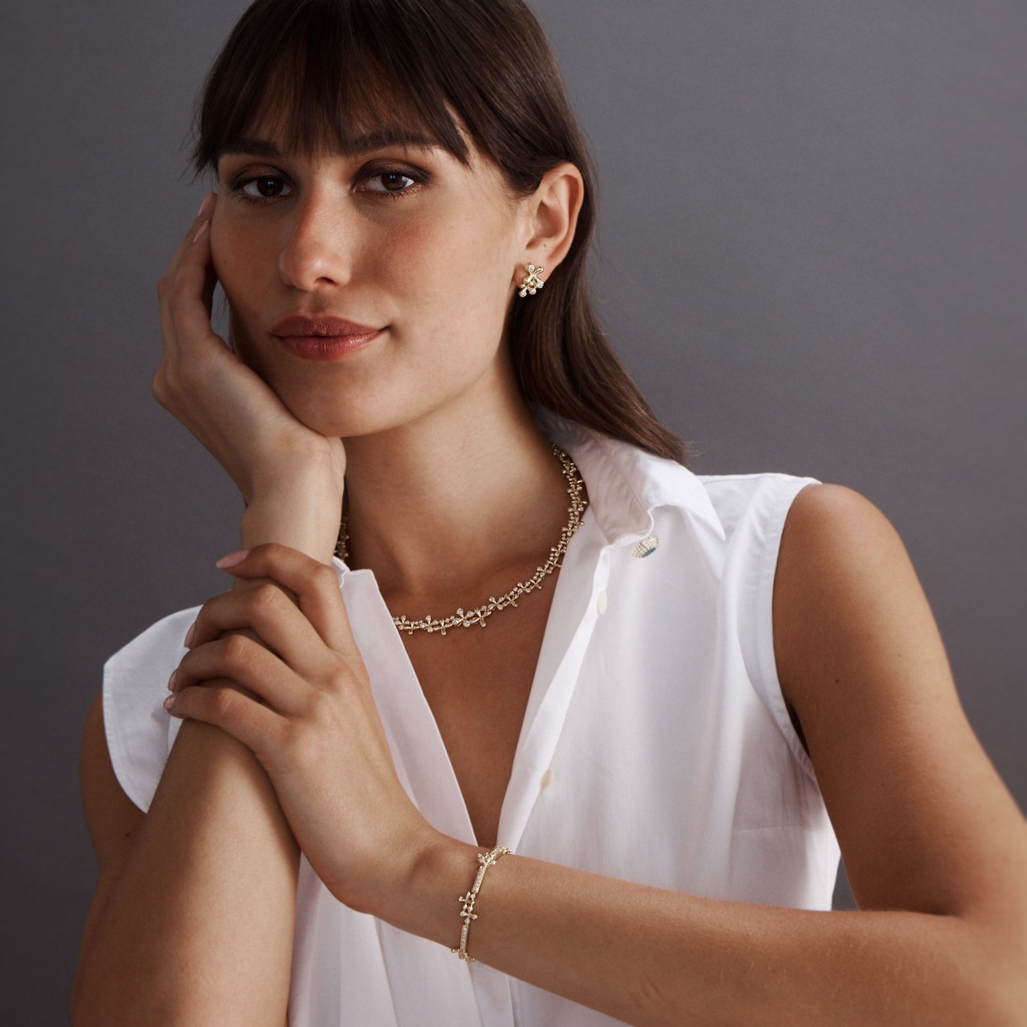 Diamond Collar in 18k yellow gold with 3.00ct natural white diamonds and graduating floral motifs, worn on model with Wildflowers collection.