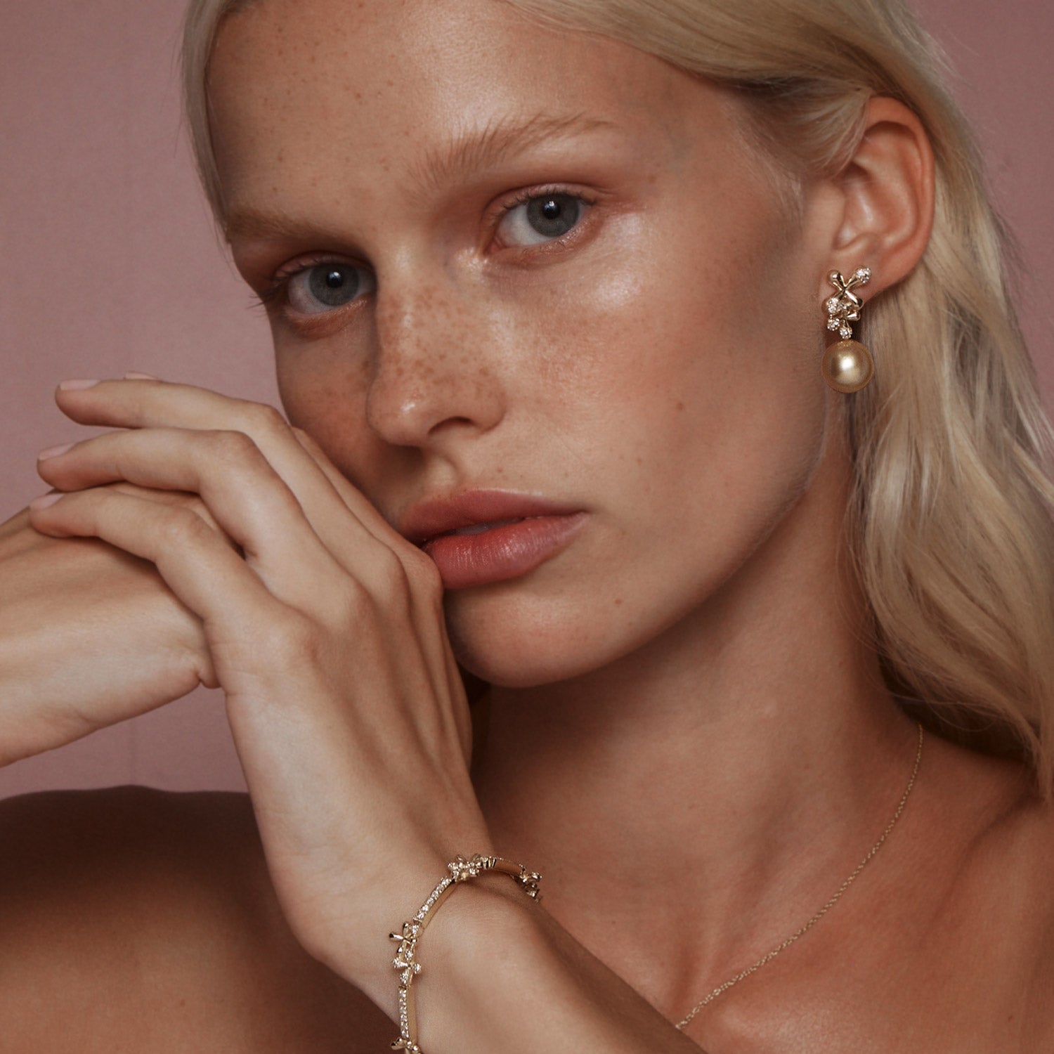 Diamond South Sea Pearl Earrings in 18k yellow gold with 0.92ct diamonds, floral motifs, and golden South Sea pearls, worn on model.