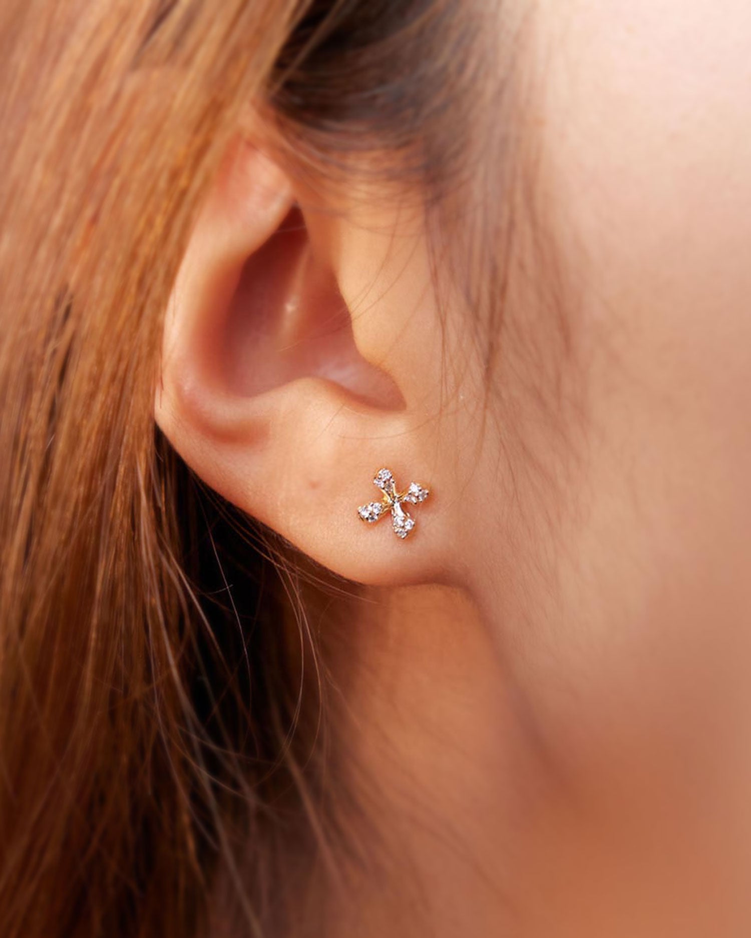 Mini Diamond Stud Earrings in 18k yellow gold with floral motif and natural diamonds on model