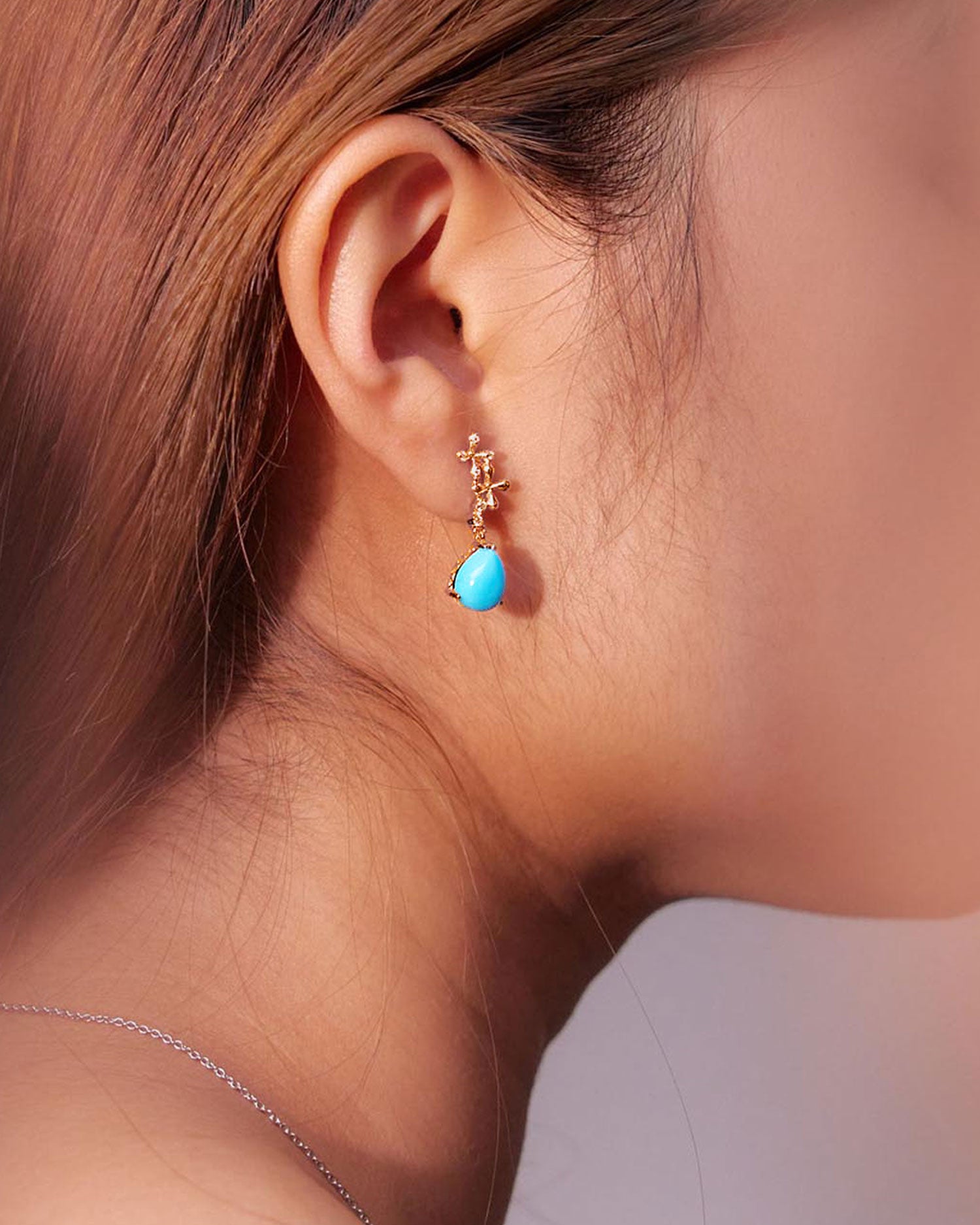 Turquoise Diamond Drop Earrings in 18k yellow gold with vivid blue turquoise drops and 0.30ct diamonds, worn on model