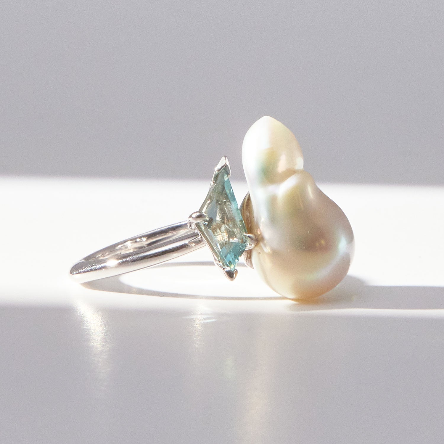 Faith Jewels Toi et Moi ring featuring a baroque pearl and fancy kite-cut aquamarine set in an 18k white gold band