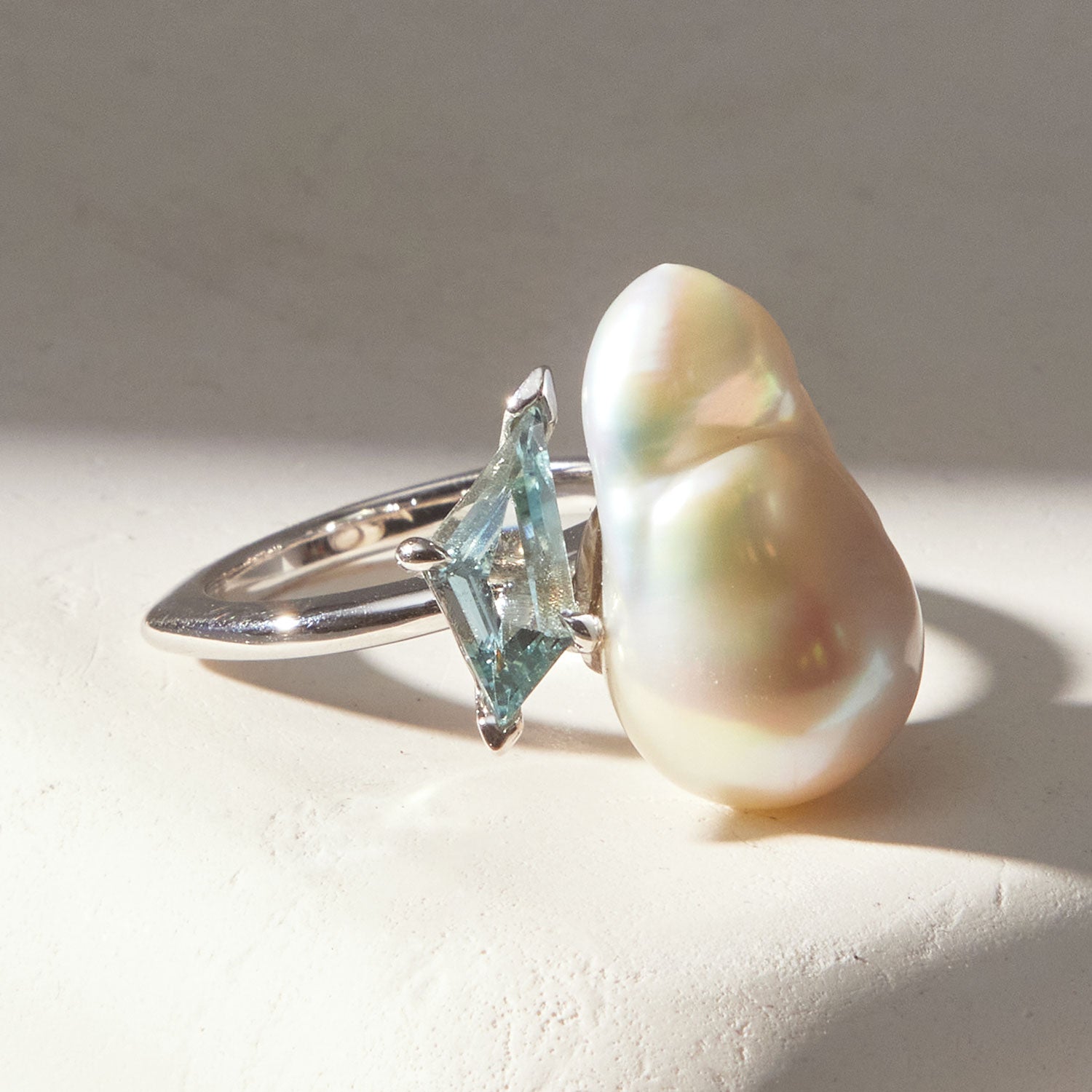 Faith Jewels Toi et Moi ring featuring a baroque pearl and fancy kite-cut aquamarine set in an 18k white gold band
