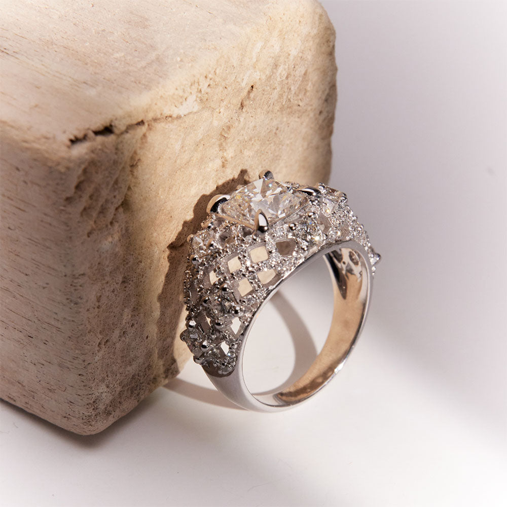 Faith Jewels White gold Pantheon Ring with a 2ct cushion-cut diamond center, surrounded by princess and round diamonds in an intricate lattice design.