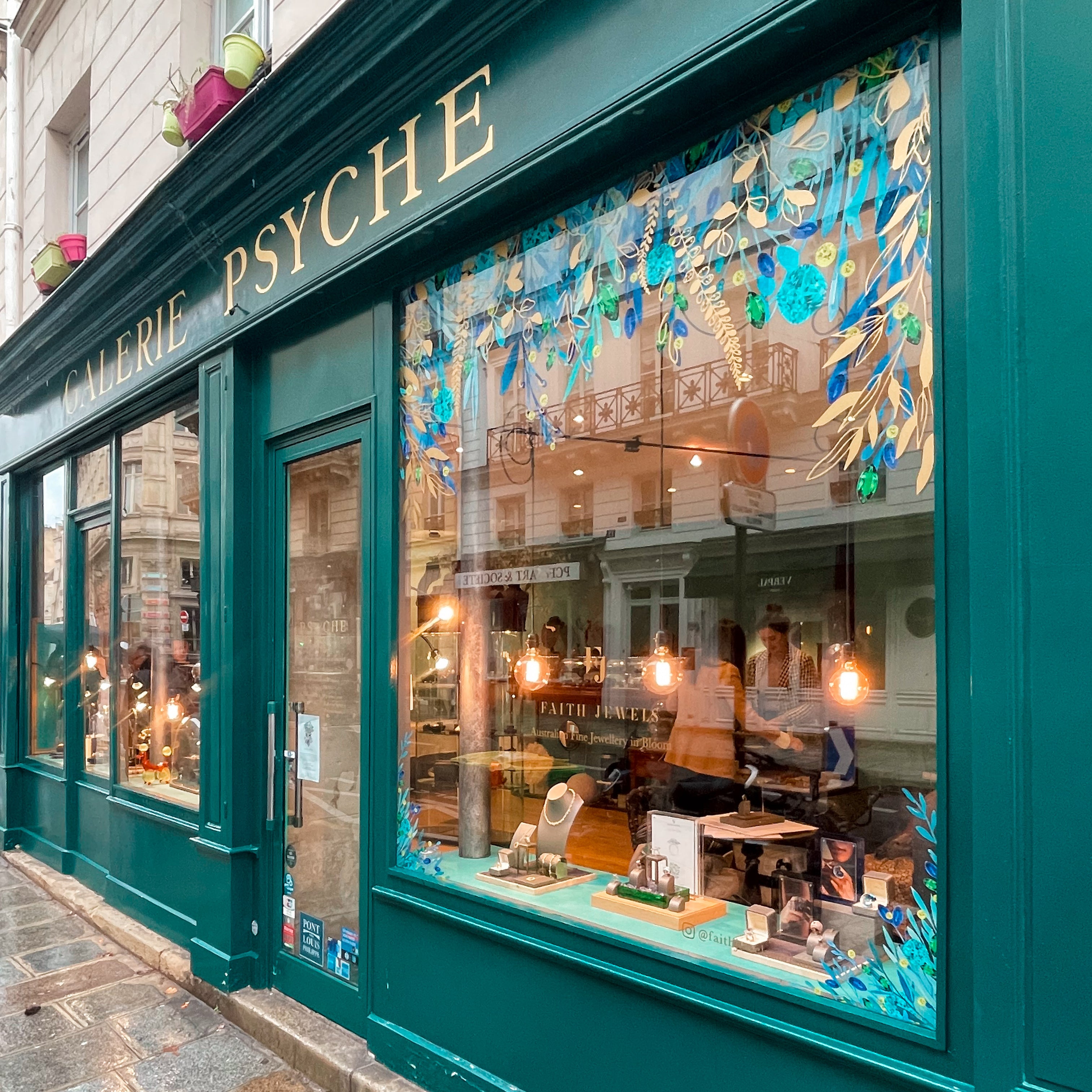 Green storefront with 'Galerie Psyche' sign and decorative window display in Paris