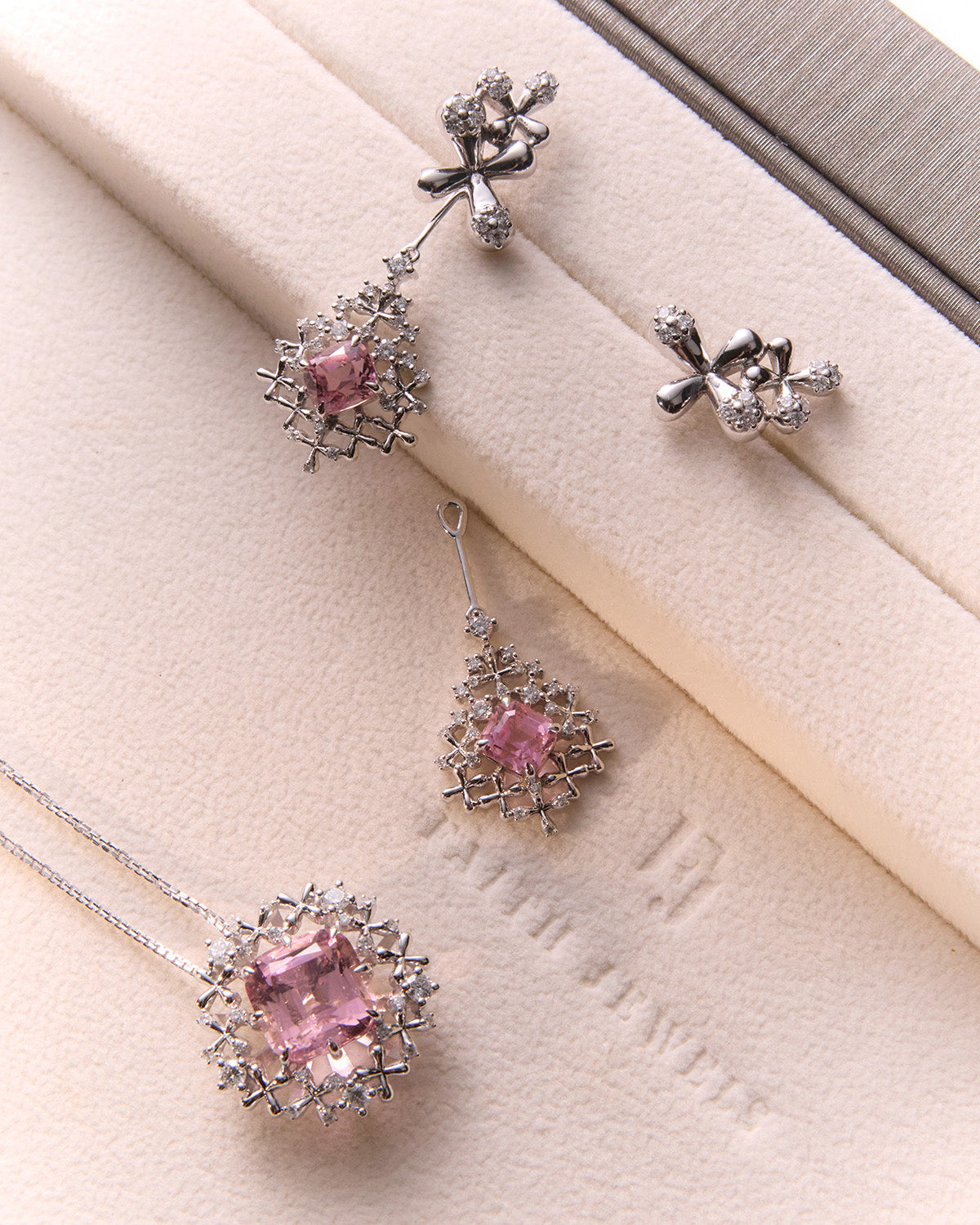 Faith Jewels Pink tourmaline pendant and earrings set in 18k white gold with diamond floral accents.
