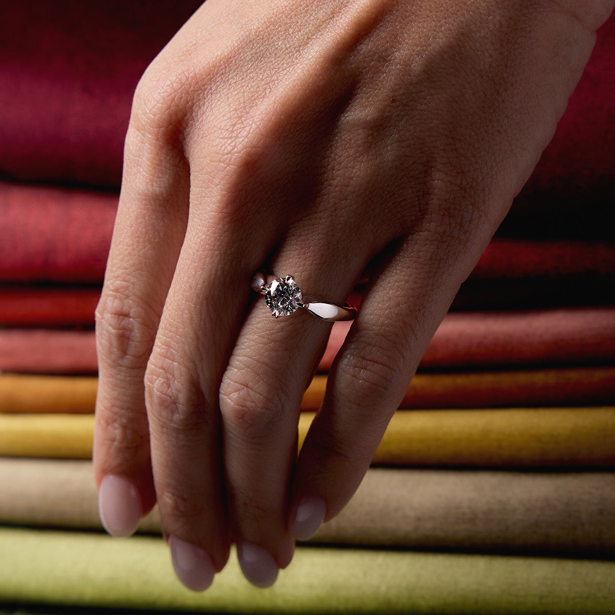 Love Today Diamond Engagement Ring in white gold with round brilliant solitaire on curved band, worn on hand model.