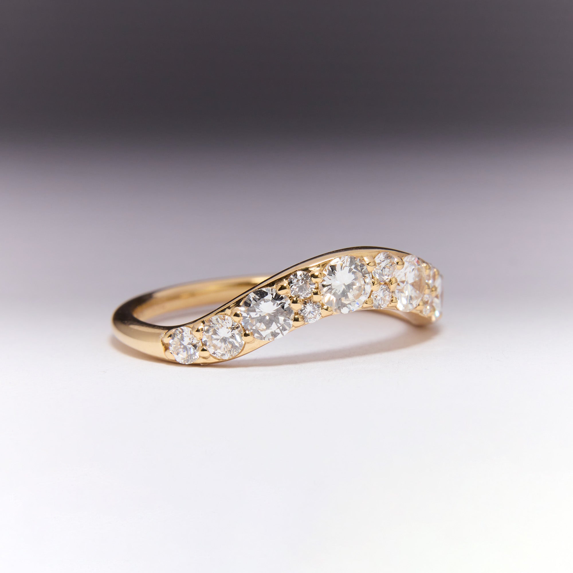 Arc Diamond Wedding Band in yellow gold, repurposed diamonds from original ring, curved design inspired by Eclipse Ring, elegant contour fit.