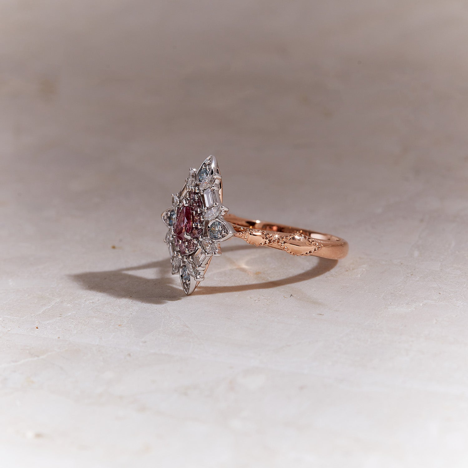 Emzo Kaleidoscope Ring with 1P pink Argyle diamond, blue and white diamonds in geometric floral design.