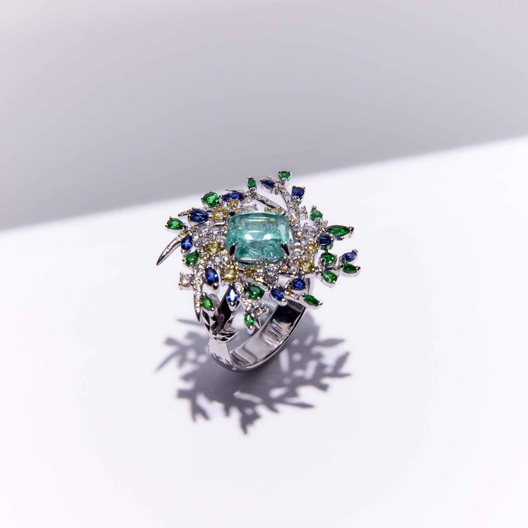 Secret garden-inspired paraiba tourmaline ring with diamonds and natural sapphires