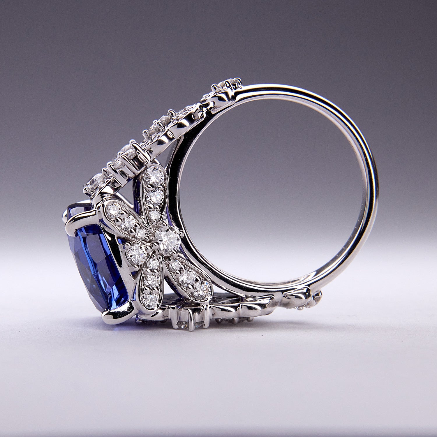 Bespoke tanzanite ring with floral-inspired white diamond accents, set in white gold