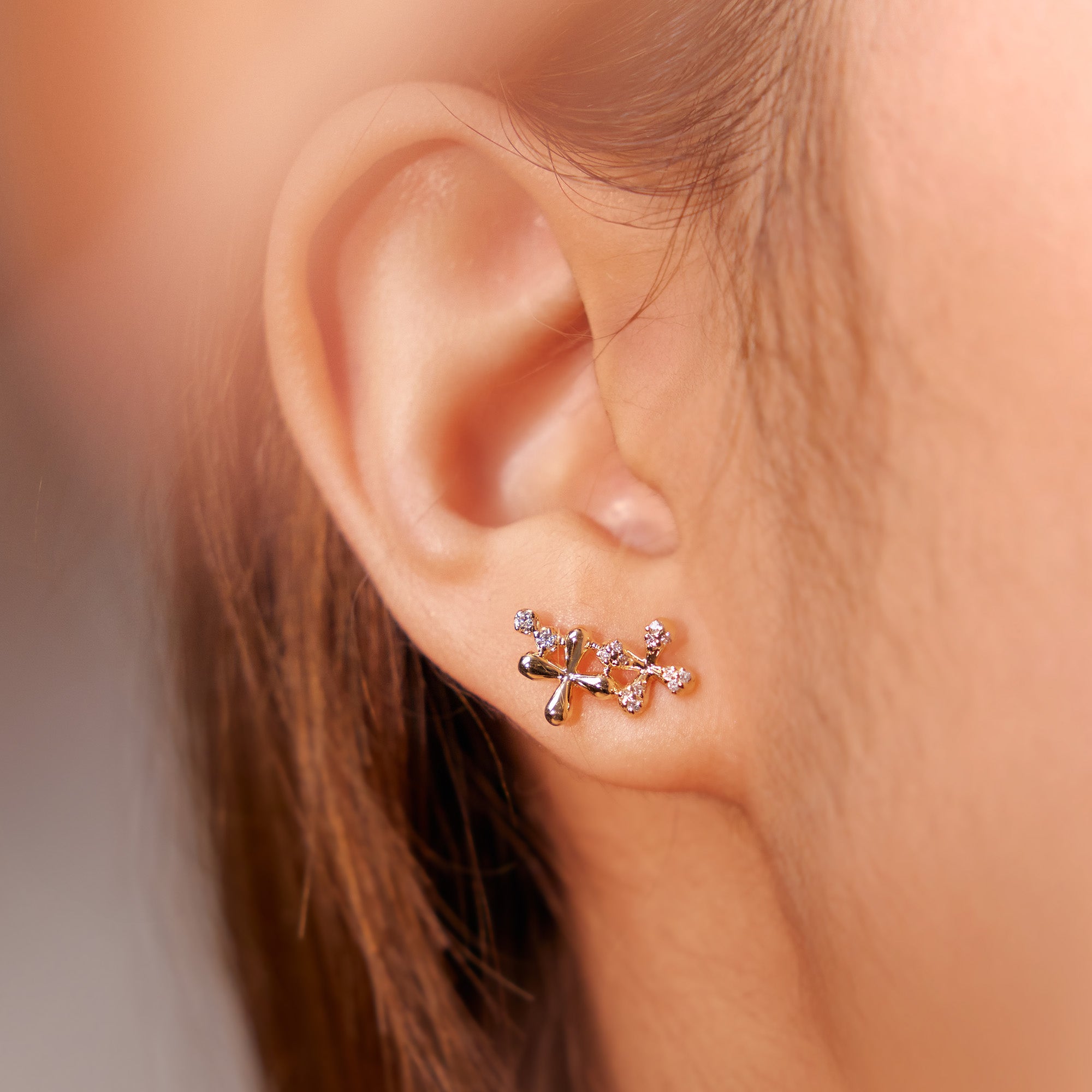 Medium Diamond Stud Earrings in 18k yellow gold with floral motifs set with 0.15ct natural diamonds, worn on model