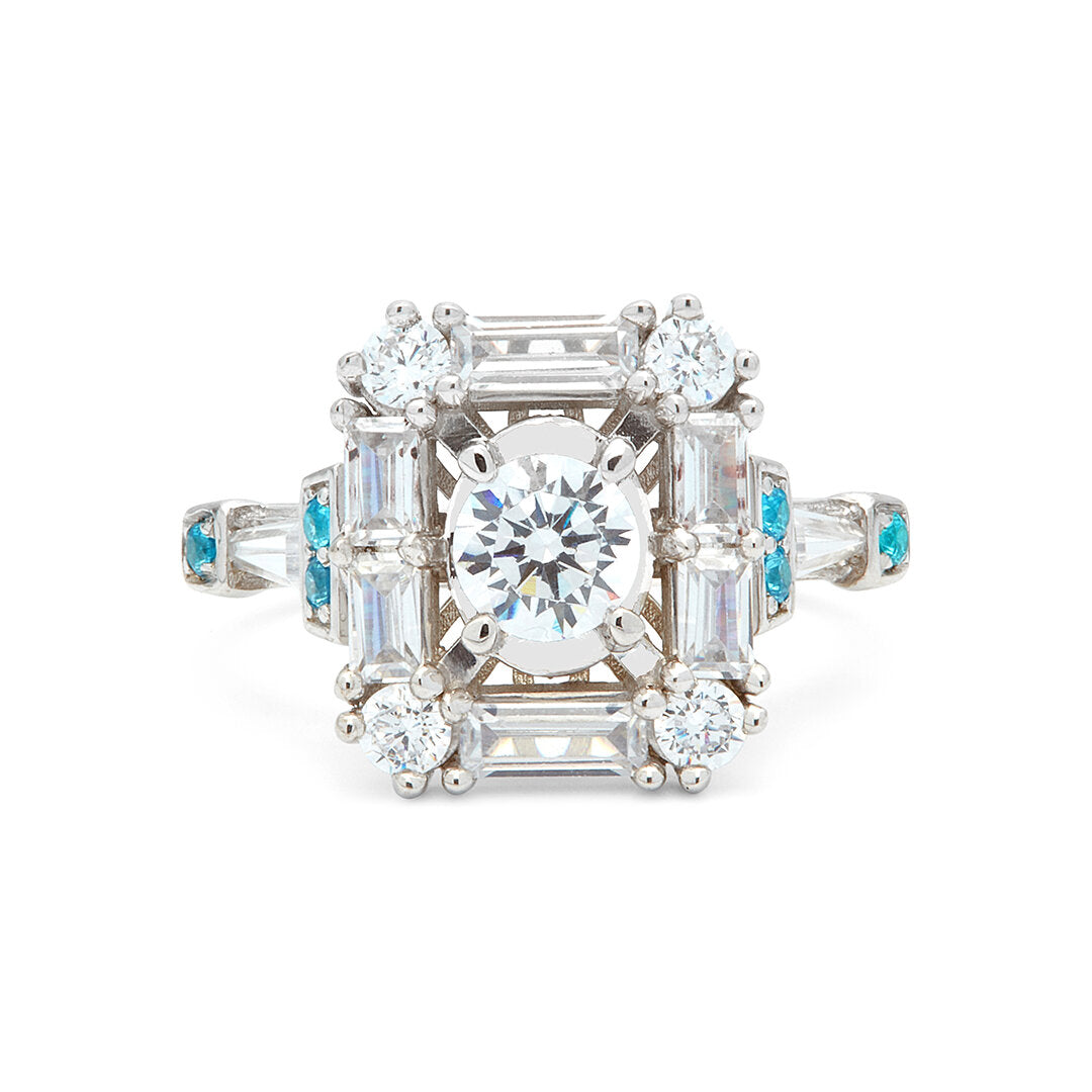 Grace aquamarine & diamond ring featuring a central diamond surrounded by baguette and brilliant-cut diamonds, accented with aquamarine, set in a geometric Art Deco-inspired design