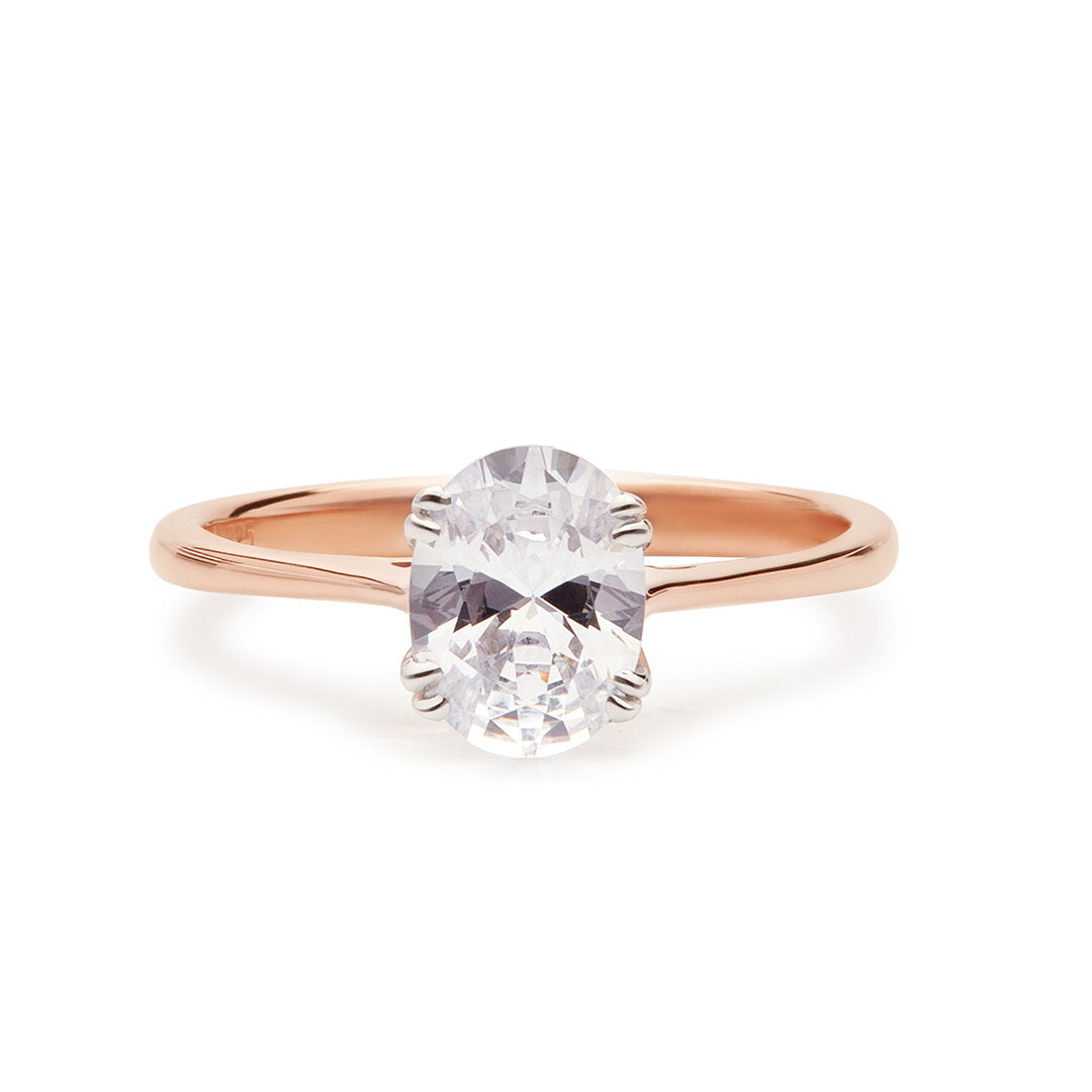 Faith Jewels Illume Diamond Engagement Ring featuring an oval-cut diamond held by four white gold prongs, set on a polished rose gold band
