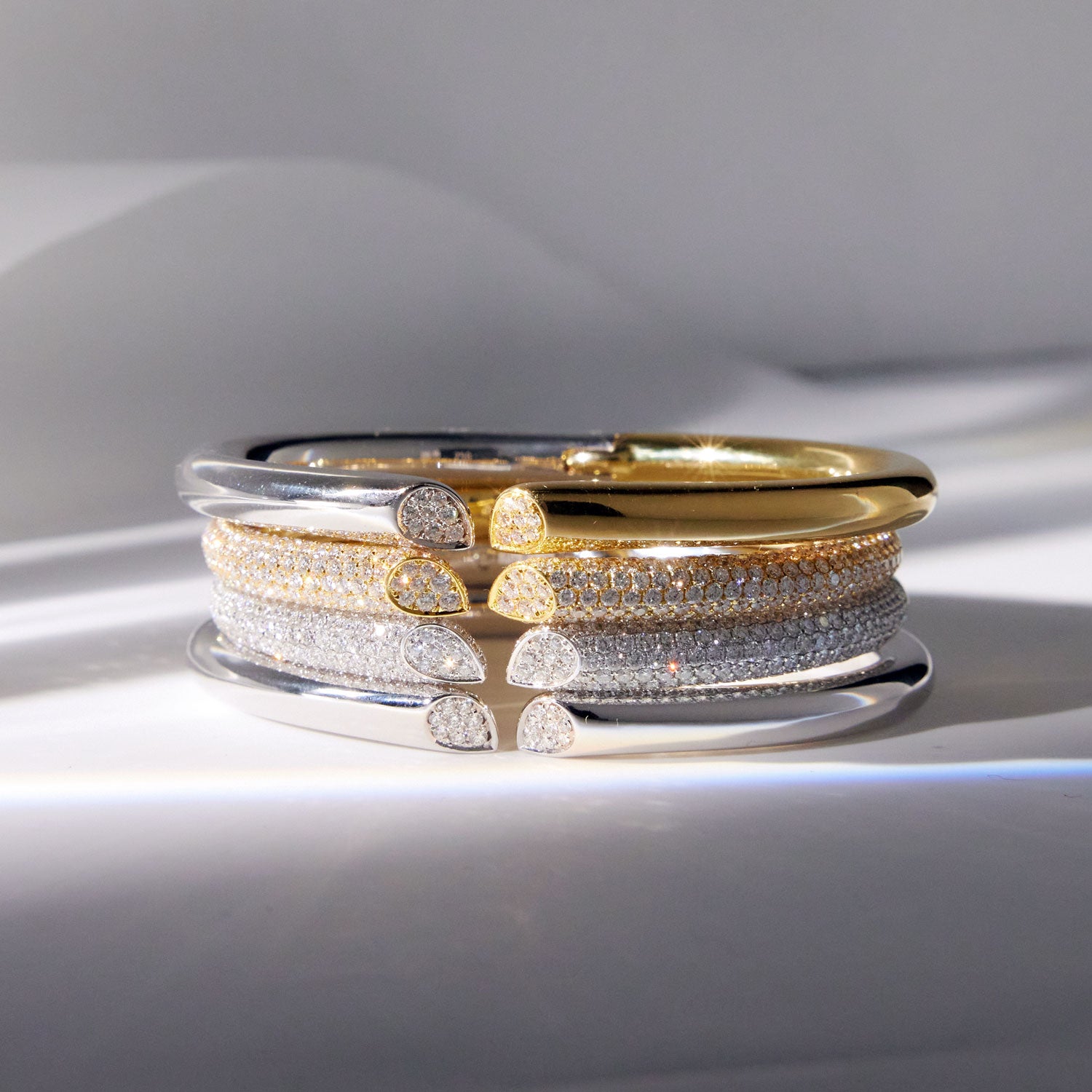 Faith Jewels 18k yellow and white gold bangle with 6.00ct pavé diamonds, featuring a heart-shaped lily petal design and secure hinge closure