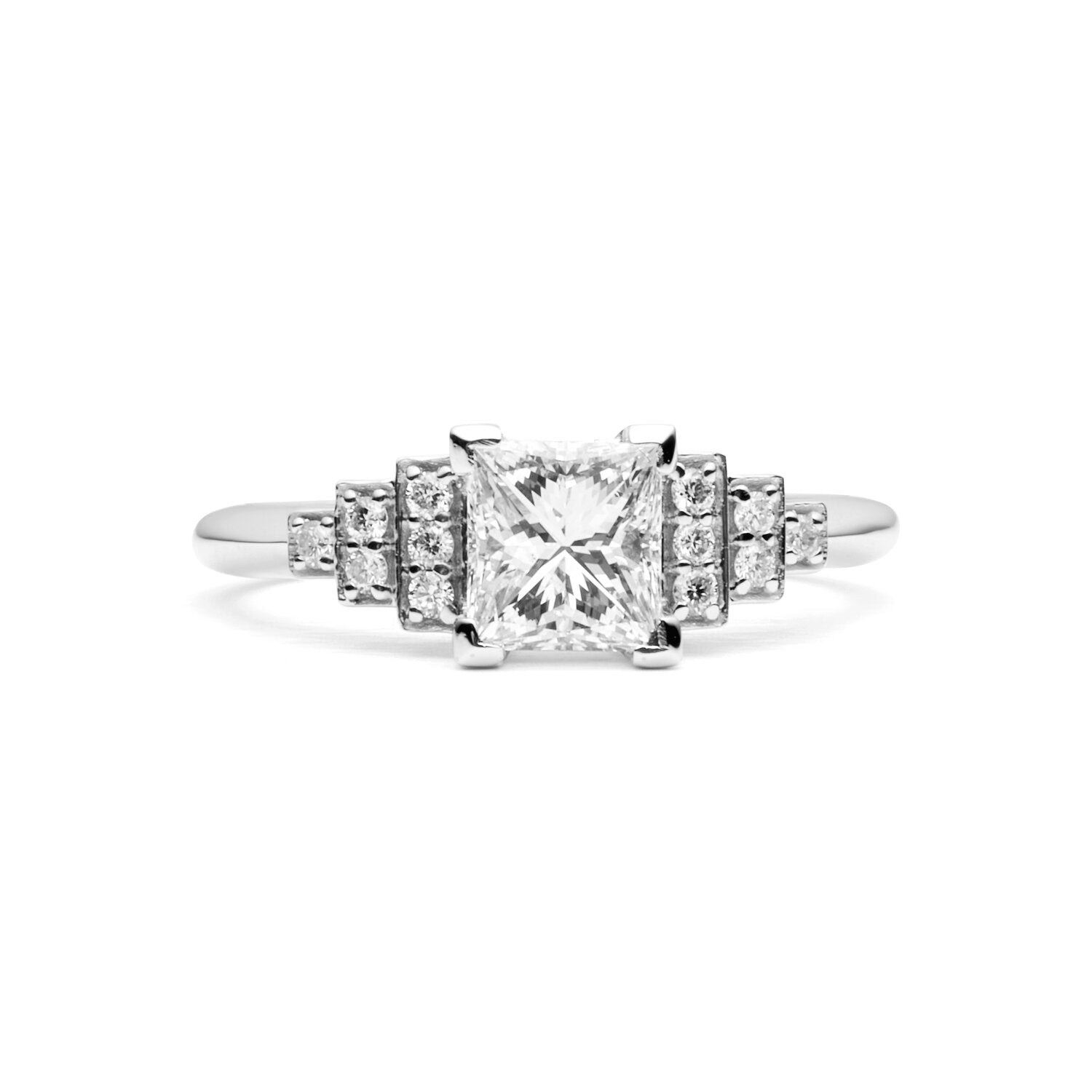 Faith Jewels Empire diamond engagement ring featuring a Princess cut center diamond, flanked by Brilliant cut diamond steps, inspired by Art Deco and the Empire State Building