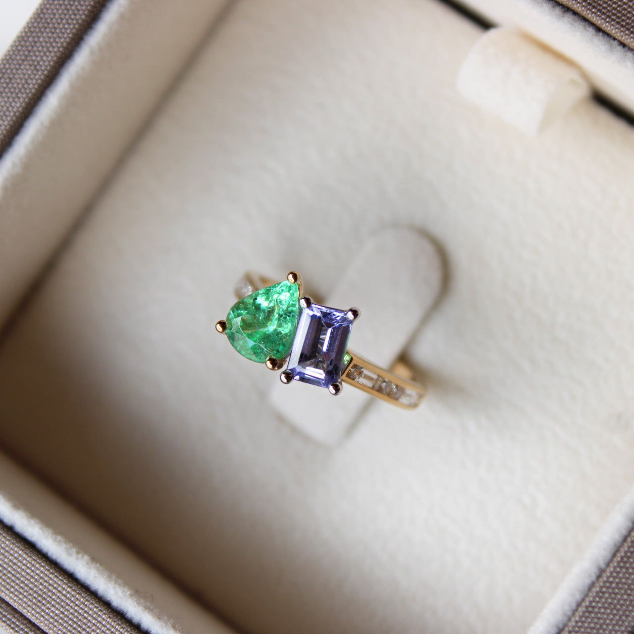 Personalised yellow gold duetto ring with Paraiba tourmaline, amethyst, and diamond Morse code initials A and D.