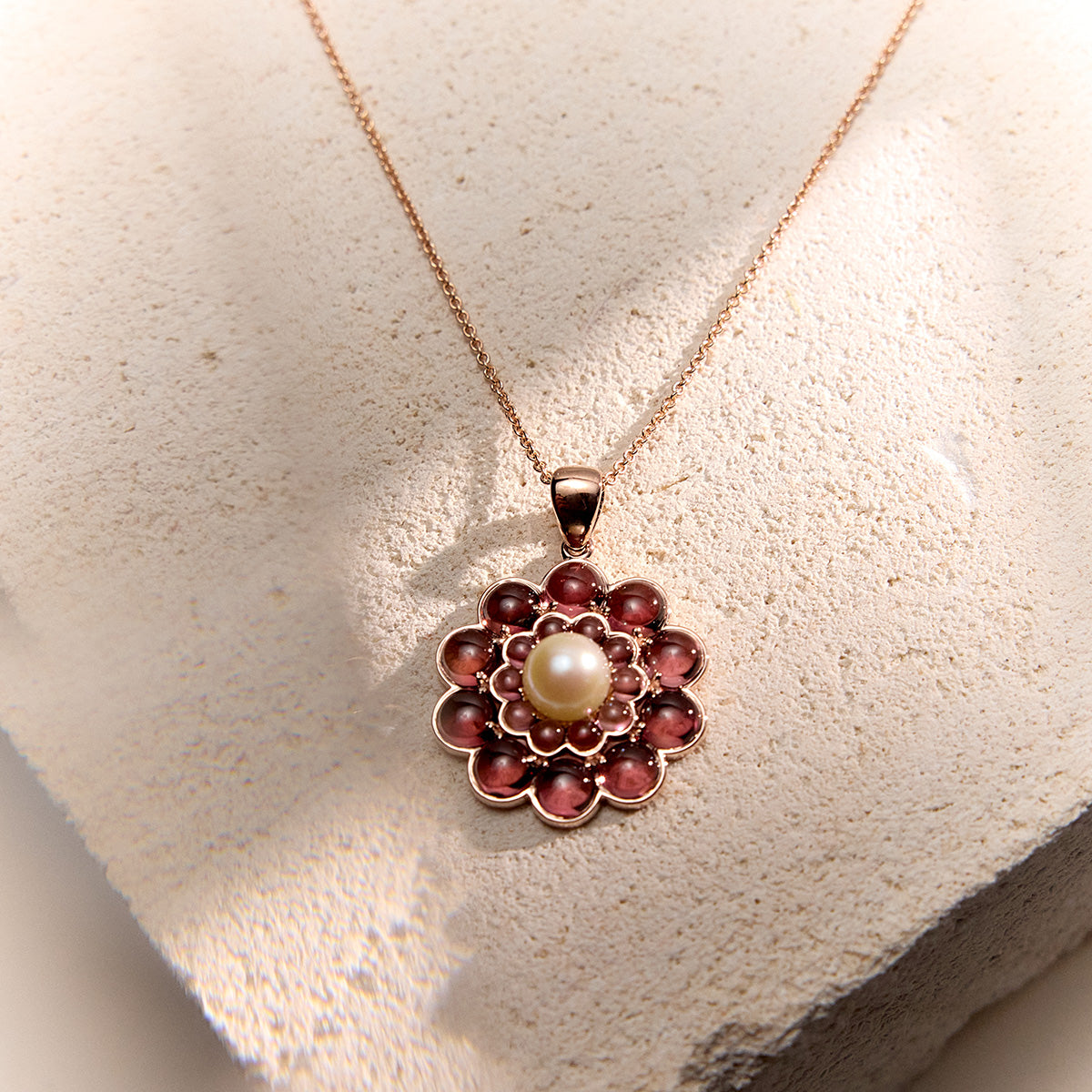 Floral-inspired pendant in 9k rose gold with pink tourmalines and repurposed pearls.
