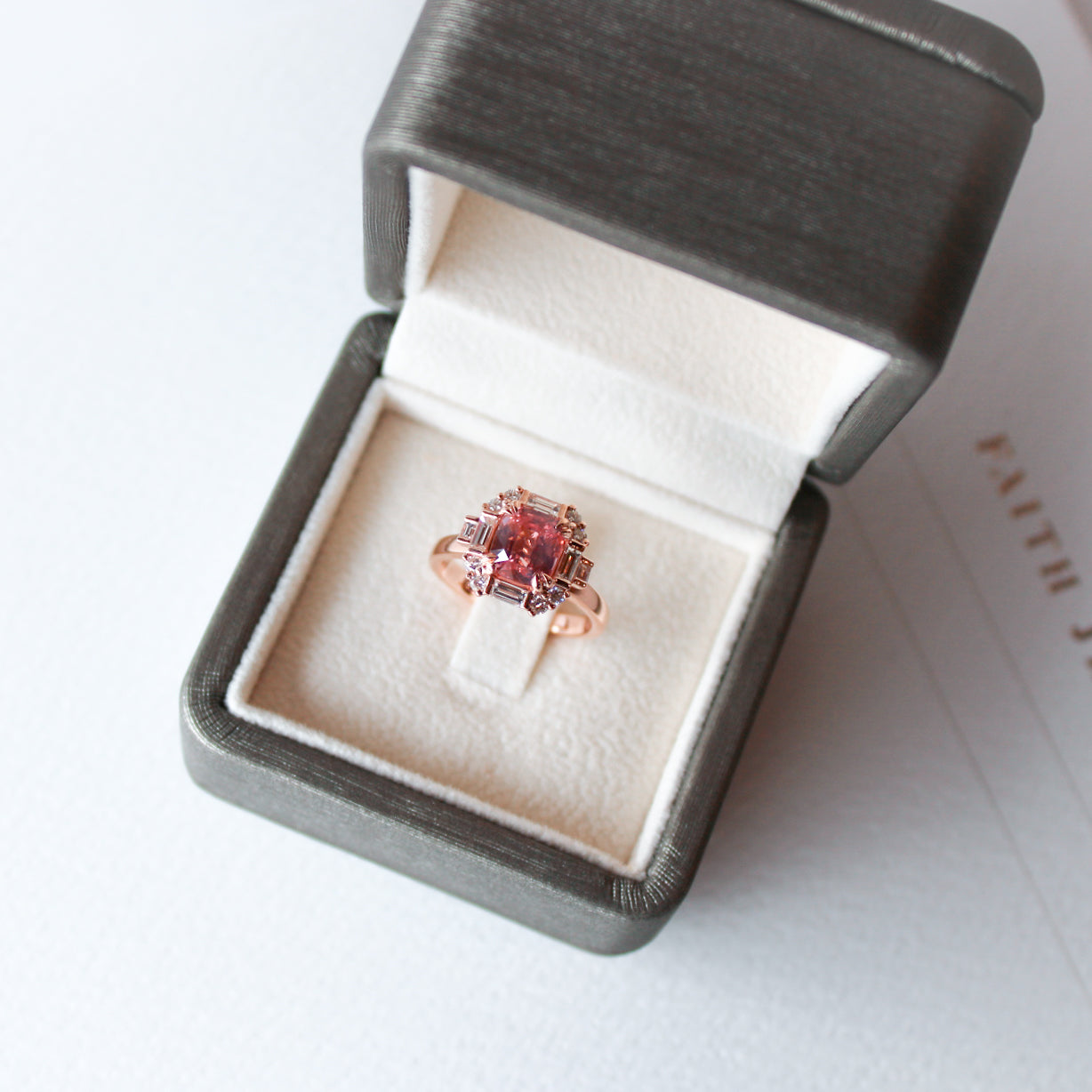 Art Deco inspired Padparadscha sapphire ring with diamonds in 18k rose gold