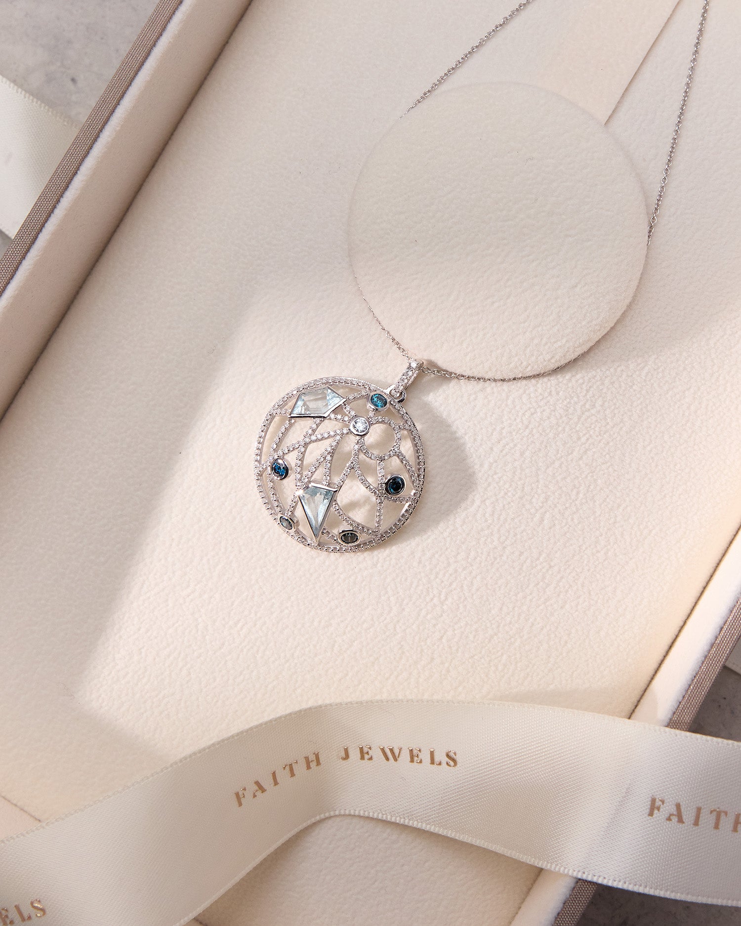 Custom Dome shape Pendant Necklace in 18k white gold with aquamarines, blue sapphires, and pavé diamonds in Faith Jewels box