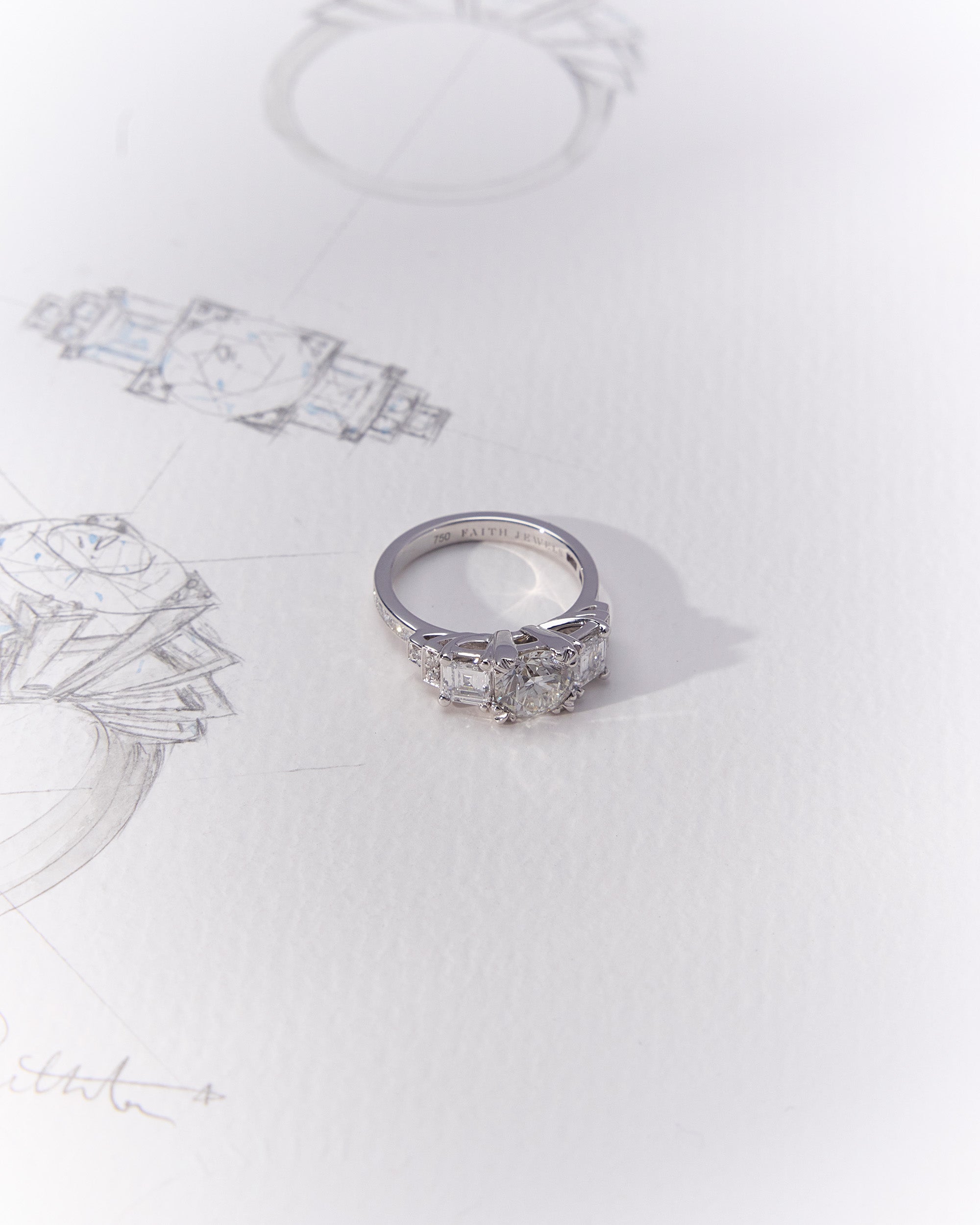 Heirloom Empire Ring with central family diamond, Art Deco trilogy design, and side diamonds in elegant setting with hand-sketched drawing
