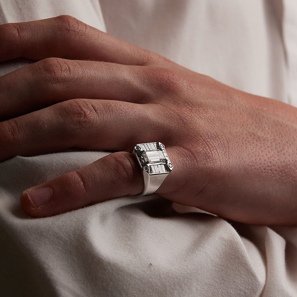 Faith Jewels White gold Gent Signet ring featuring a 1.50ct emerald-cut diamond surrounded by baguette diamonds on model