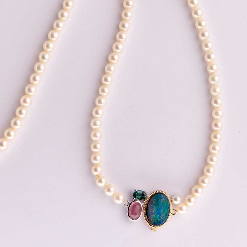 Faith Jewels Heirloom pearl necklace with a unique clasp made from opal, tourmaline, and mixed metals, blending family gemstones into a modern statement piece.