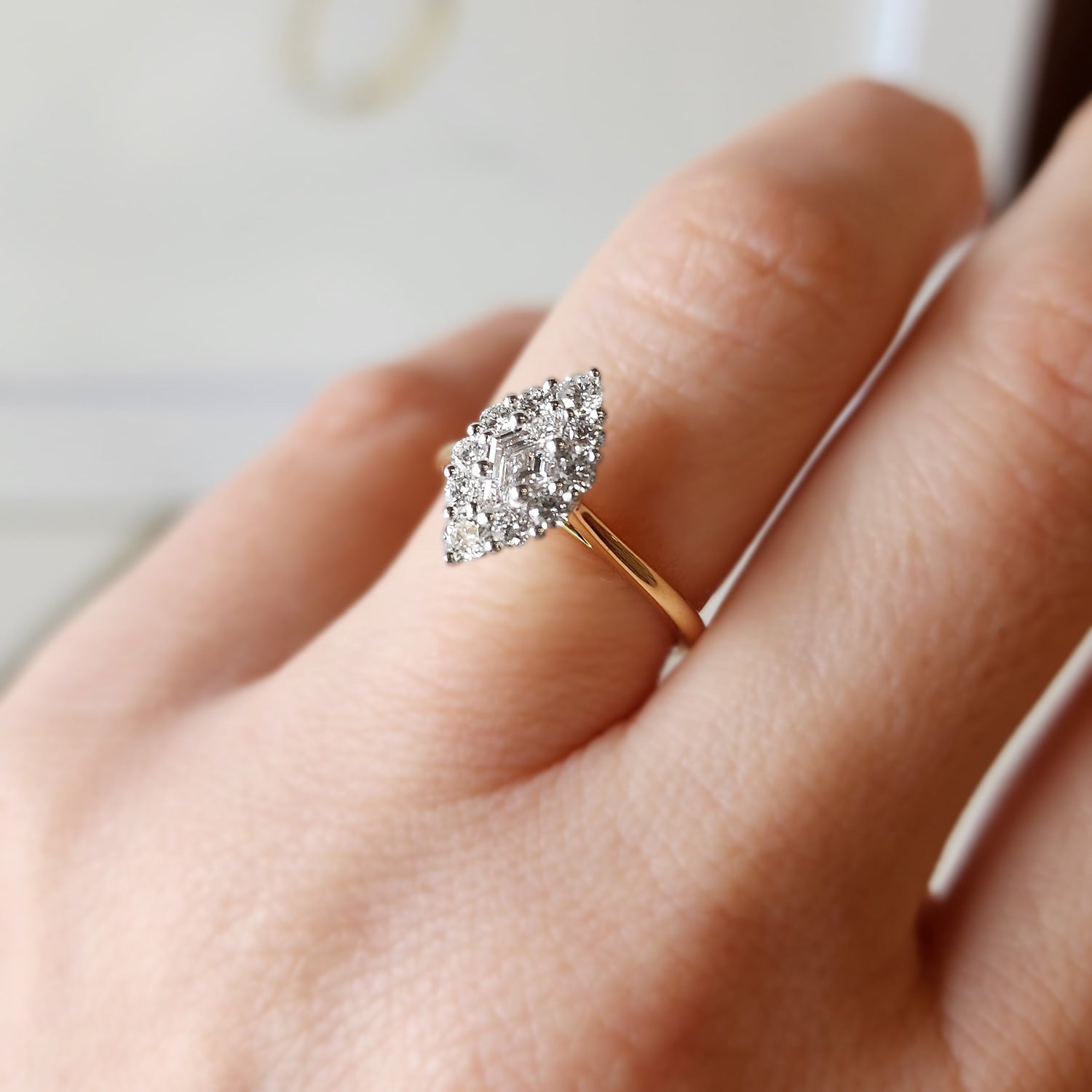 Faith Jewels Adeline Diamond Ring featuring a 0.29ct lozenge step-cut D colour diamond with a halo of round white diamonds, set in 18k white and yellow gold