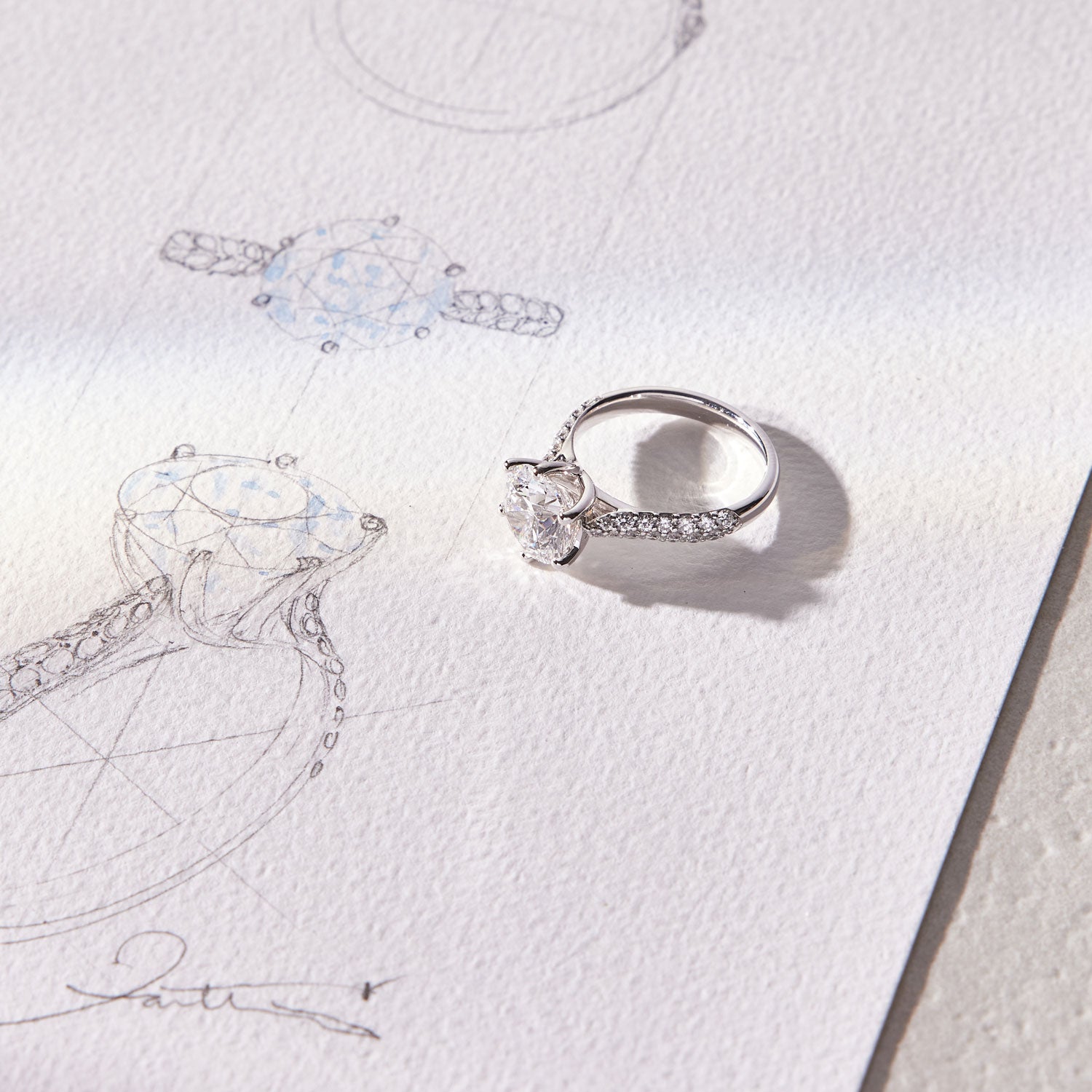 Faith Jewels Arlene diamond engagement ring featuring a 3ct round brilliant-cut solitaire diamond in a twist-setting with an asymmetrical pavé diamond band