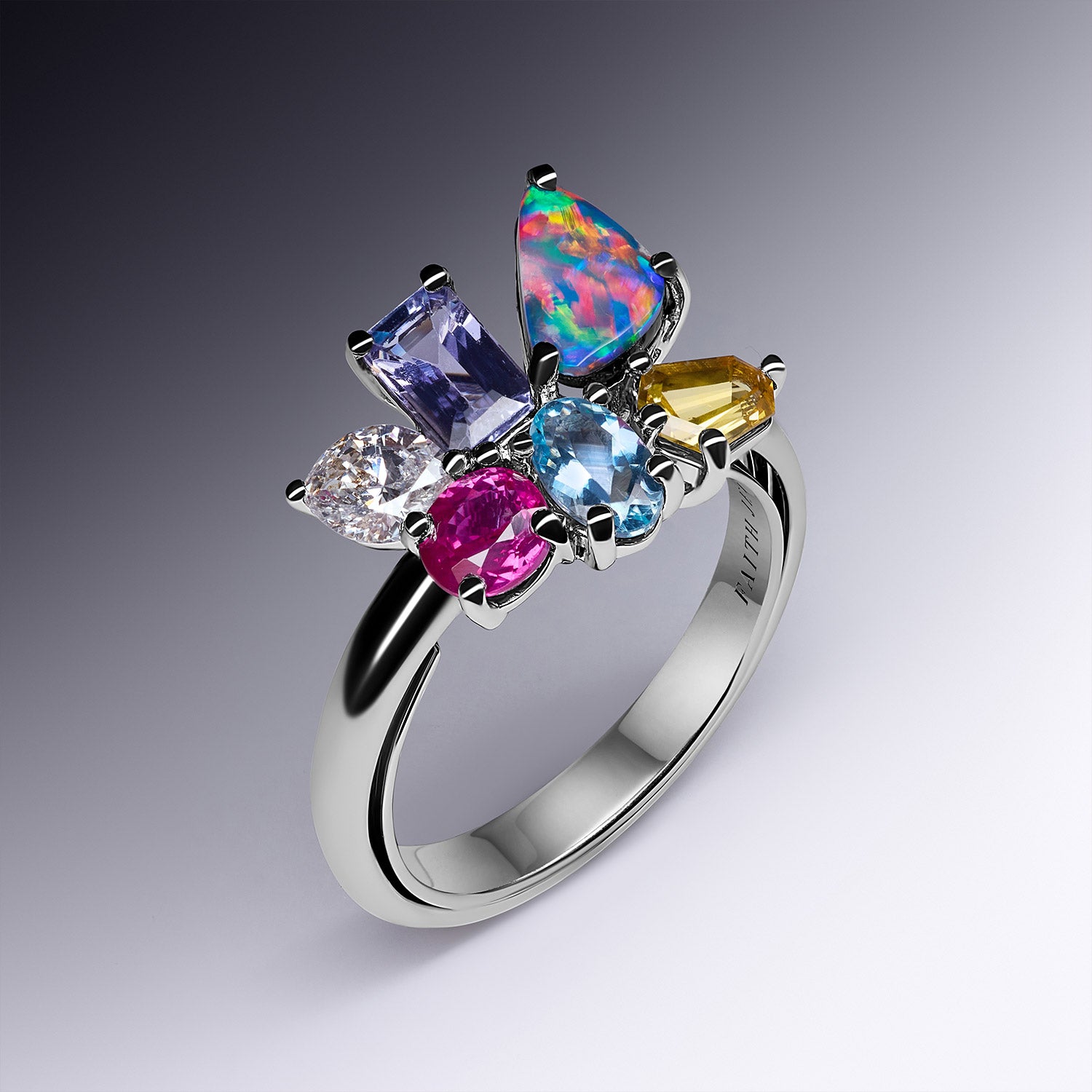Hazel birthstone white gold band ring featuring aquamarine, diamond, opal, ruby, citrine, and tanzanite arranged in a colourful design, symbolizing family