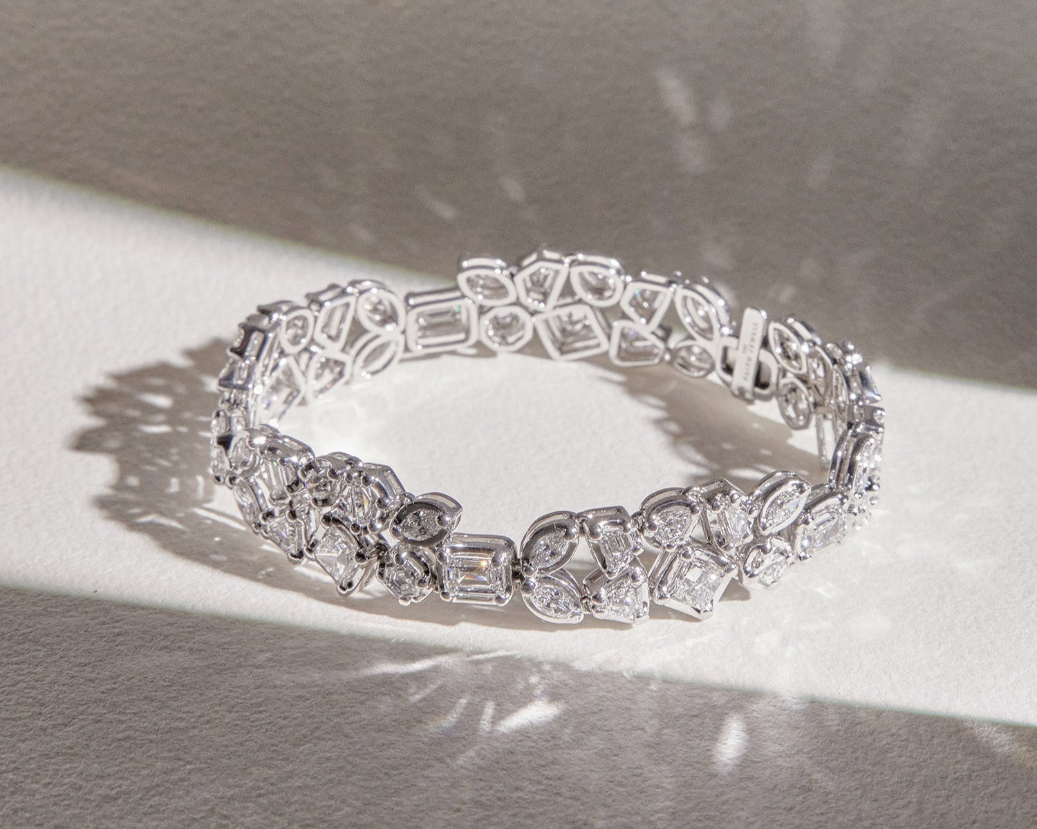 Faith Jewels Bouquet Diamond Bracelet featuring a mix of Marquis, Pear, Hexagon, Shield, Trapezoid, Epaulette, Emerald, and Princess-cut diamonds totaling 10.10 carats