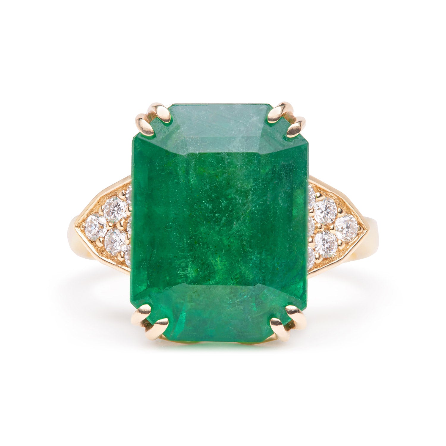 Emerald-cut emerald ring with grain-set diamond accents, set in a yellow gold band.