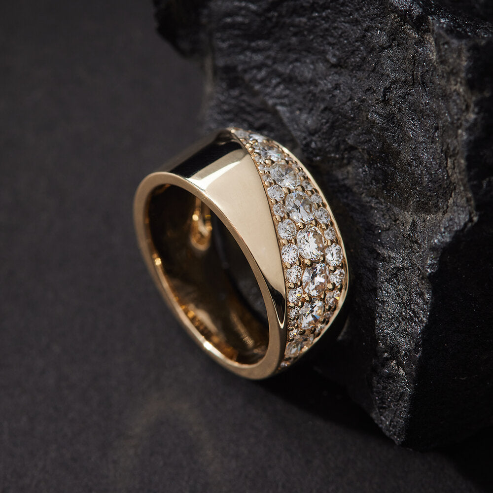 Faith Jewels Faros Wide Diamond Ring in 9k yellow gold featuring a Möbius-inspired curved design with high polish and pavé-set white diamonds totaling 1.10 carats